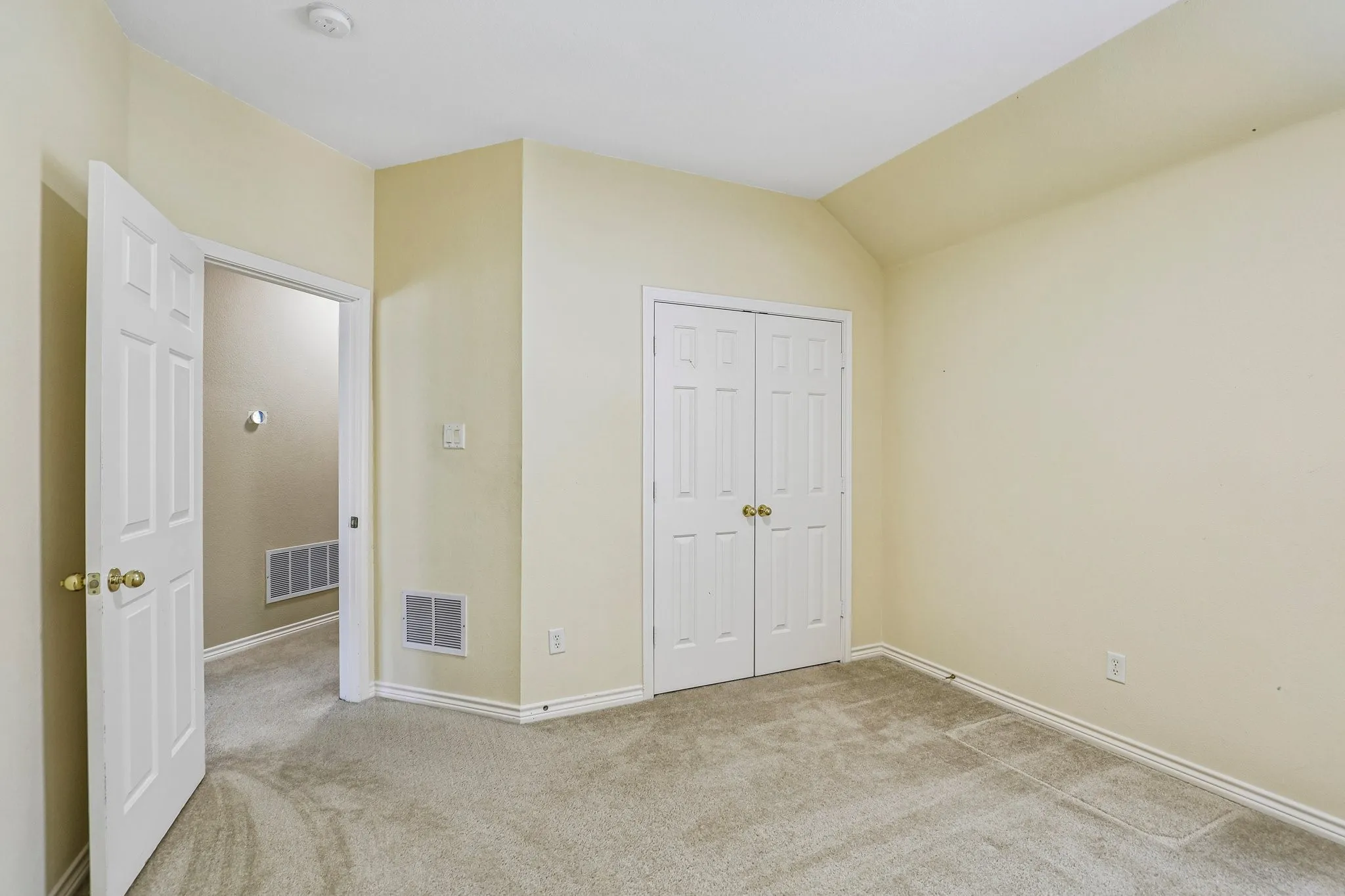 Upstairs bedroom with double-door closet.
