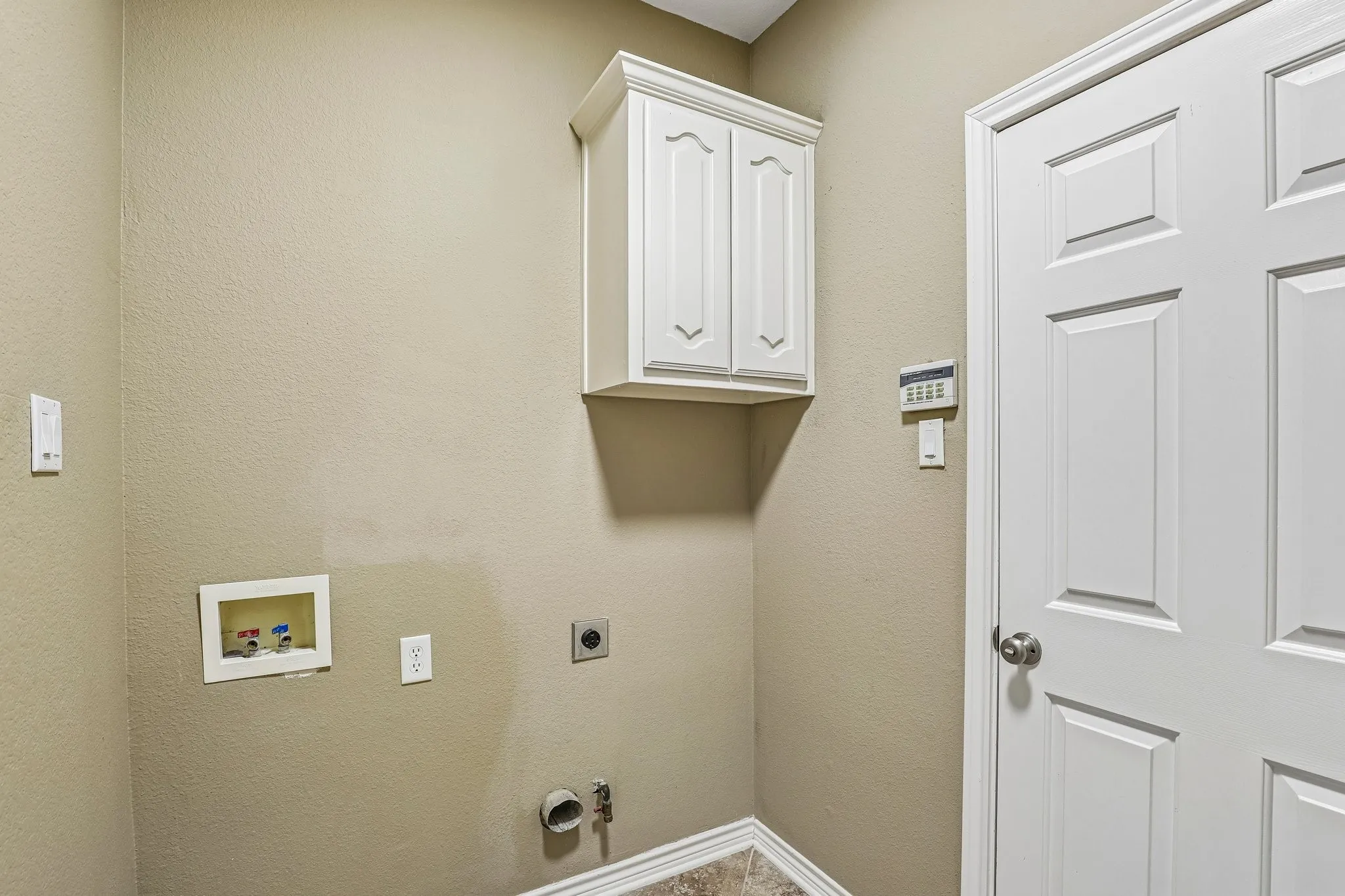 Laundry room with cabinetry.