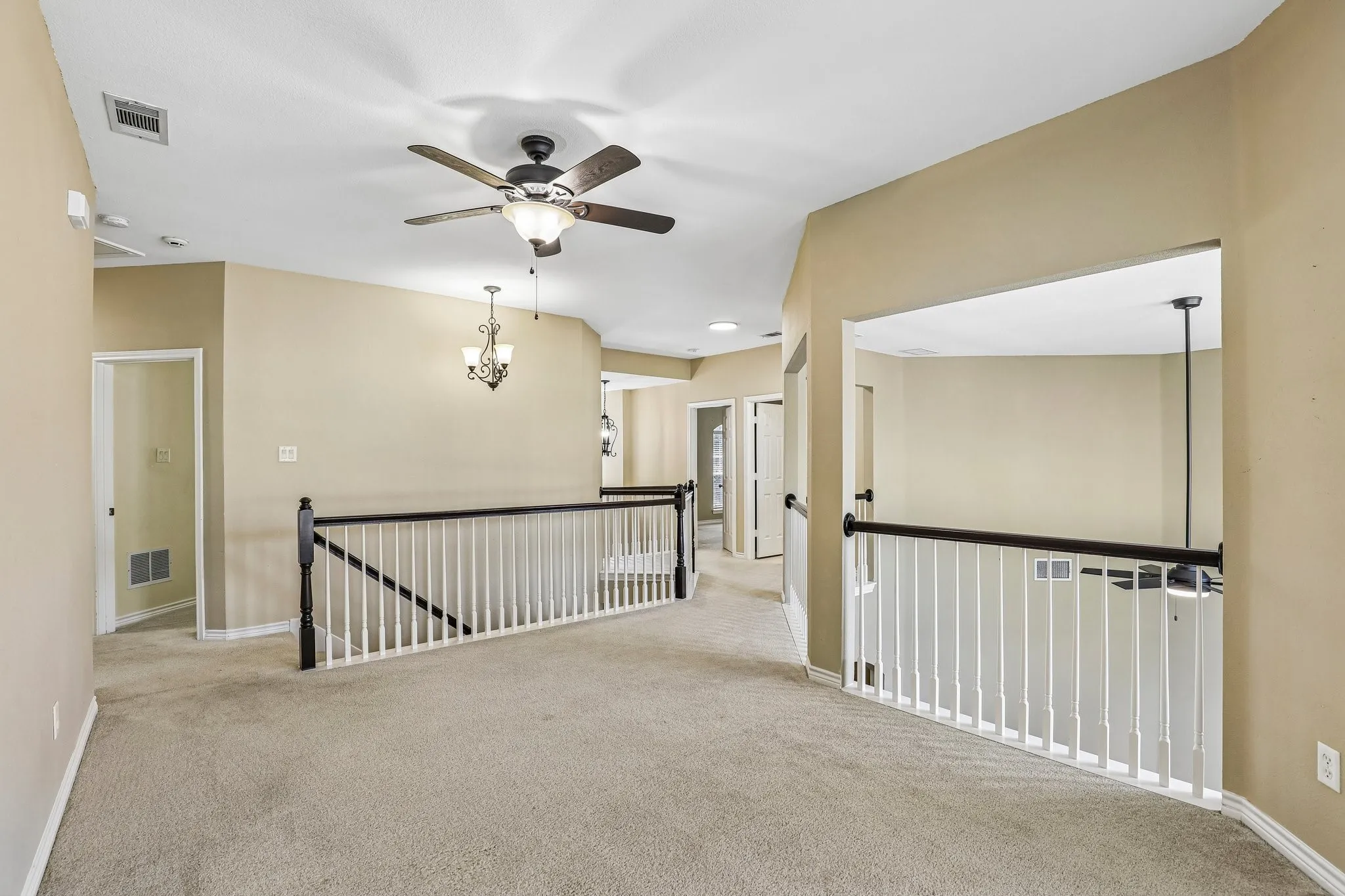 Upstairs bonus room with balconies overlooking the first floor.