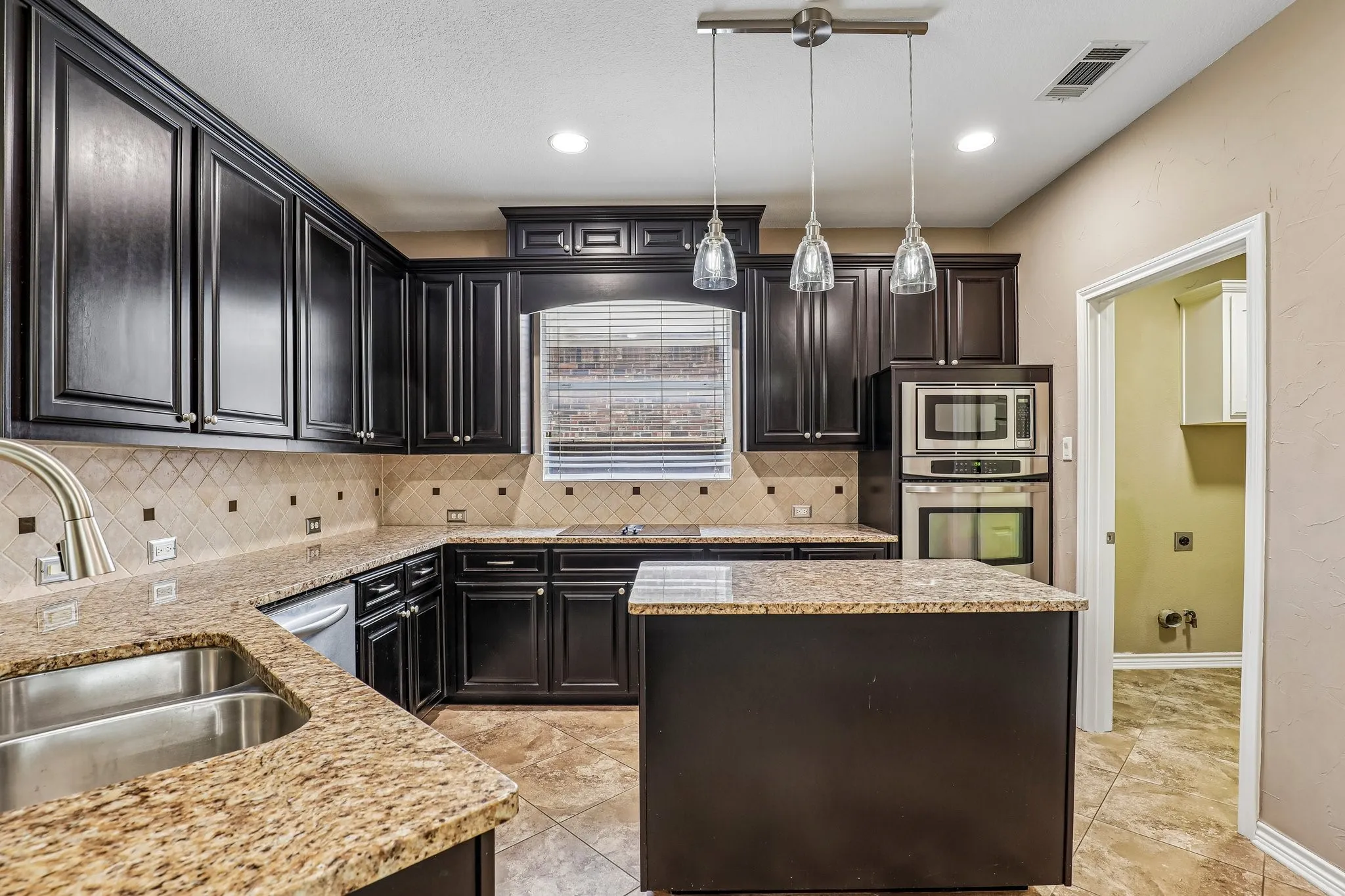 Kitchen with granite countertops and stainless steel appliances.