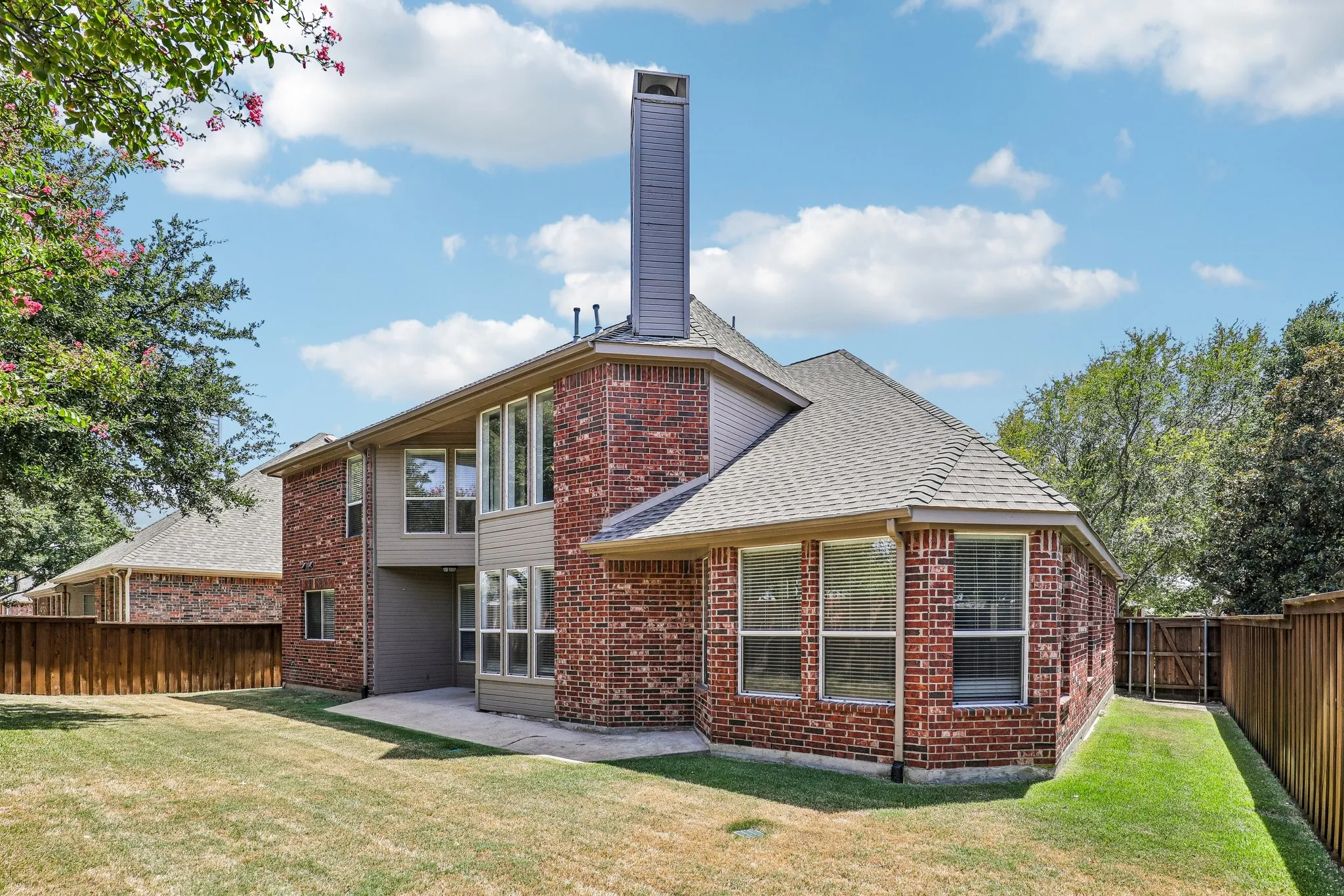 Backyard featuring covered patio and side yards.