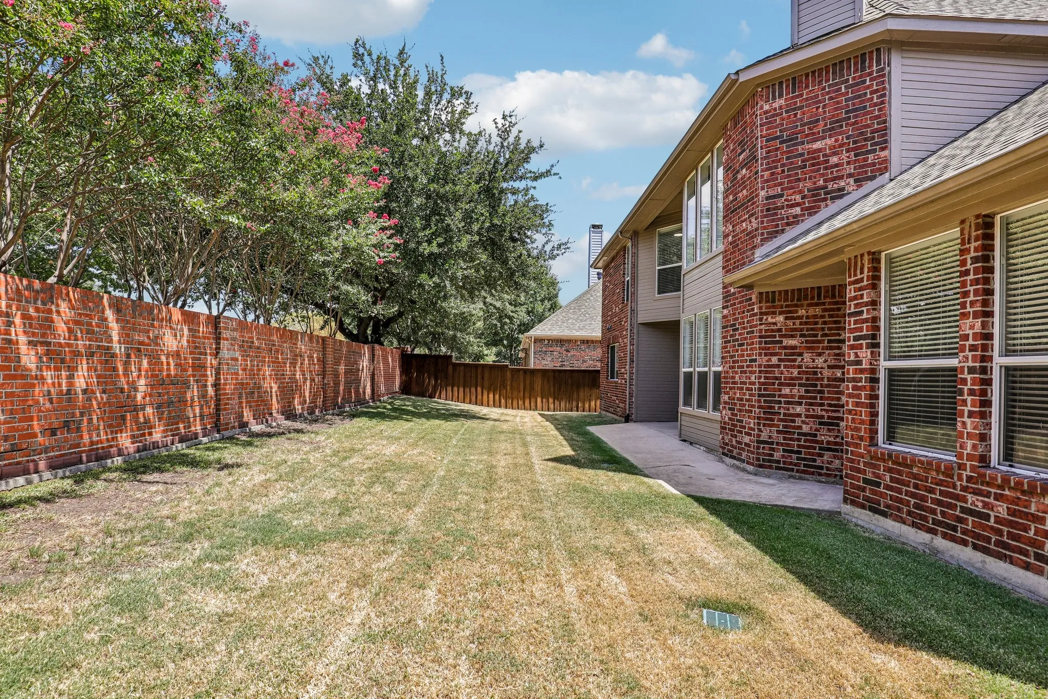 Private backyard surrounded with privacy fencing.