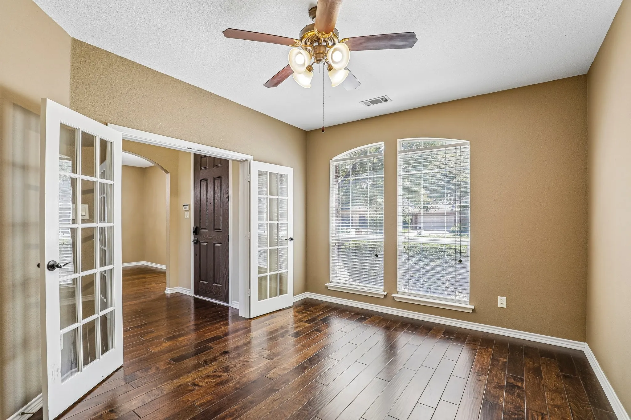Dedicated office overlooking the front of the home with glass French door entry.
