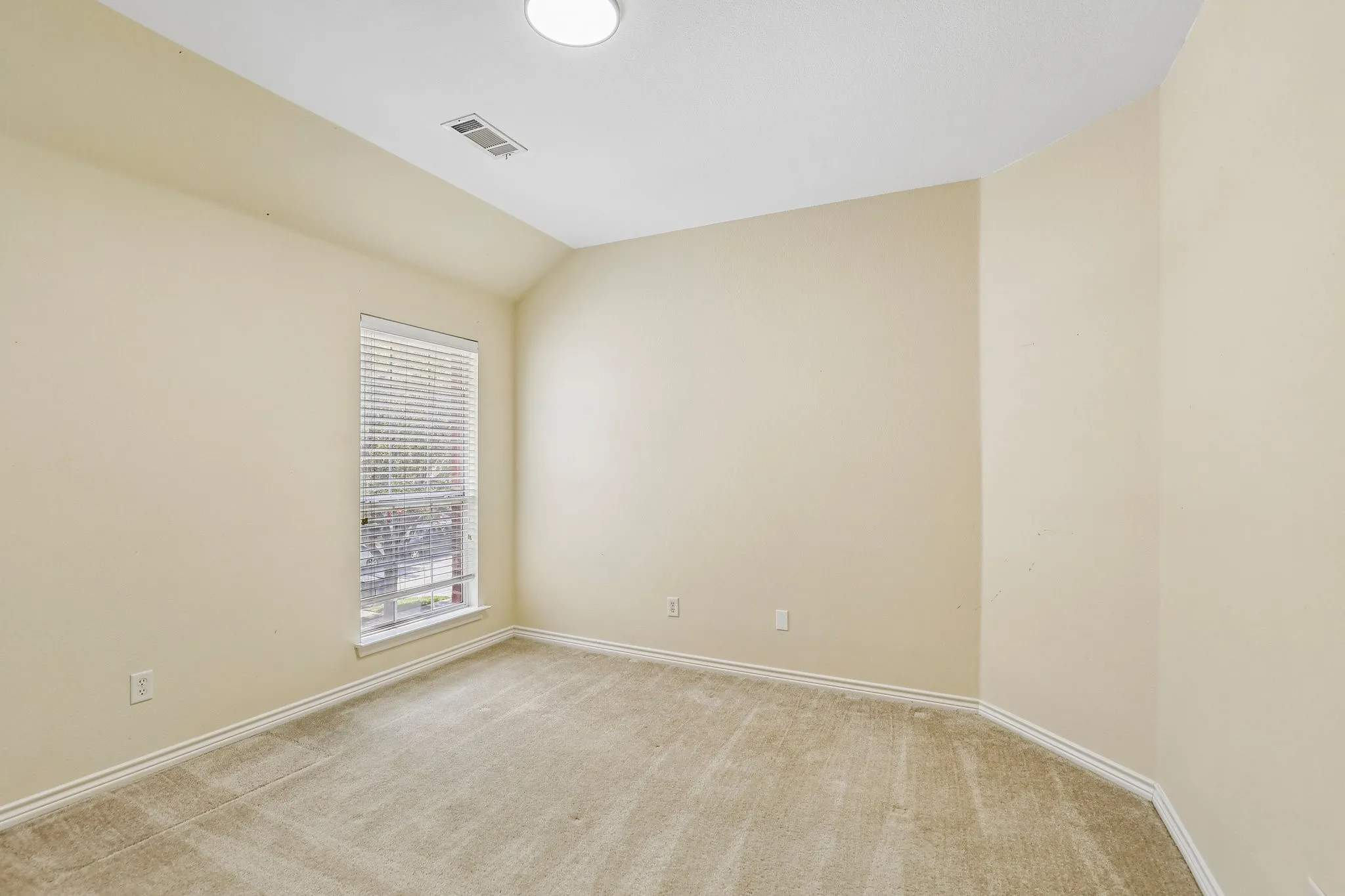 Upstairs bedroom with sloped ceiling.