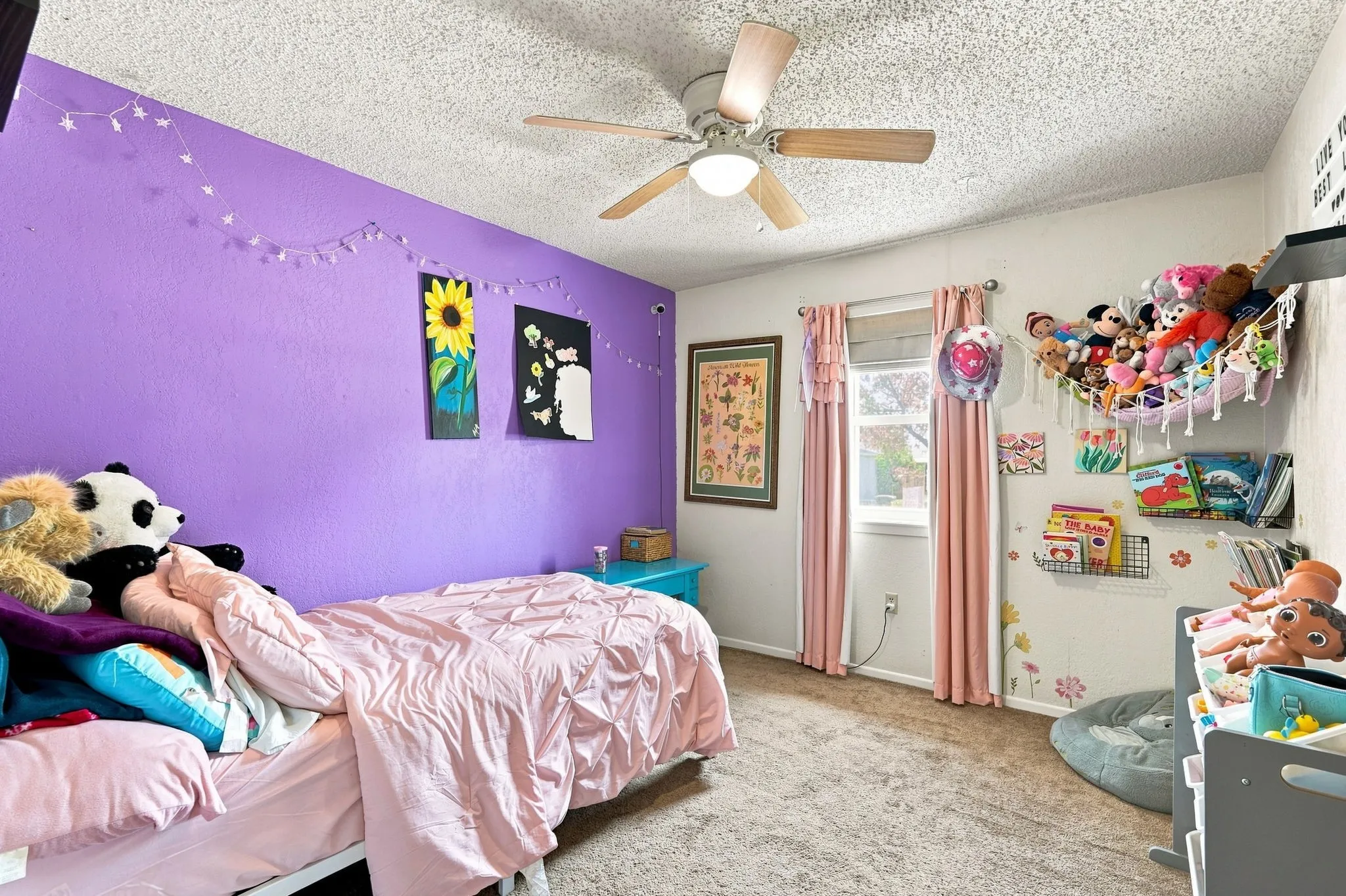 Textured ceiling with a ceiling fan, carpeted flooring, and a single window with curtain rods