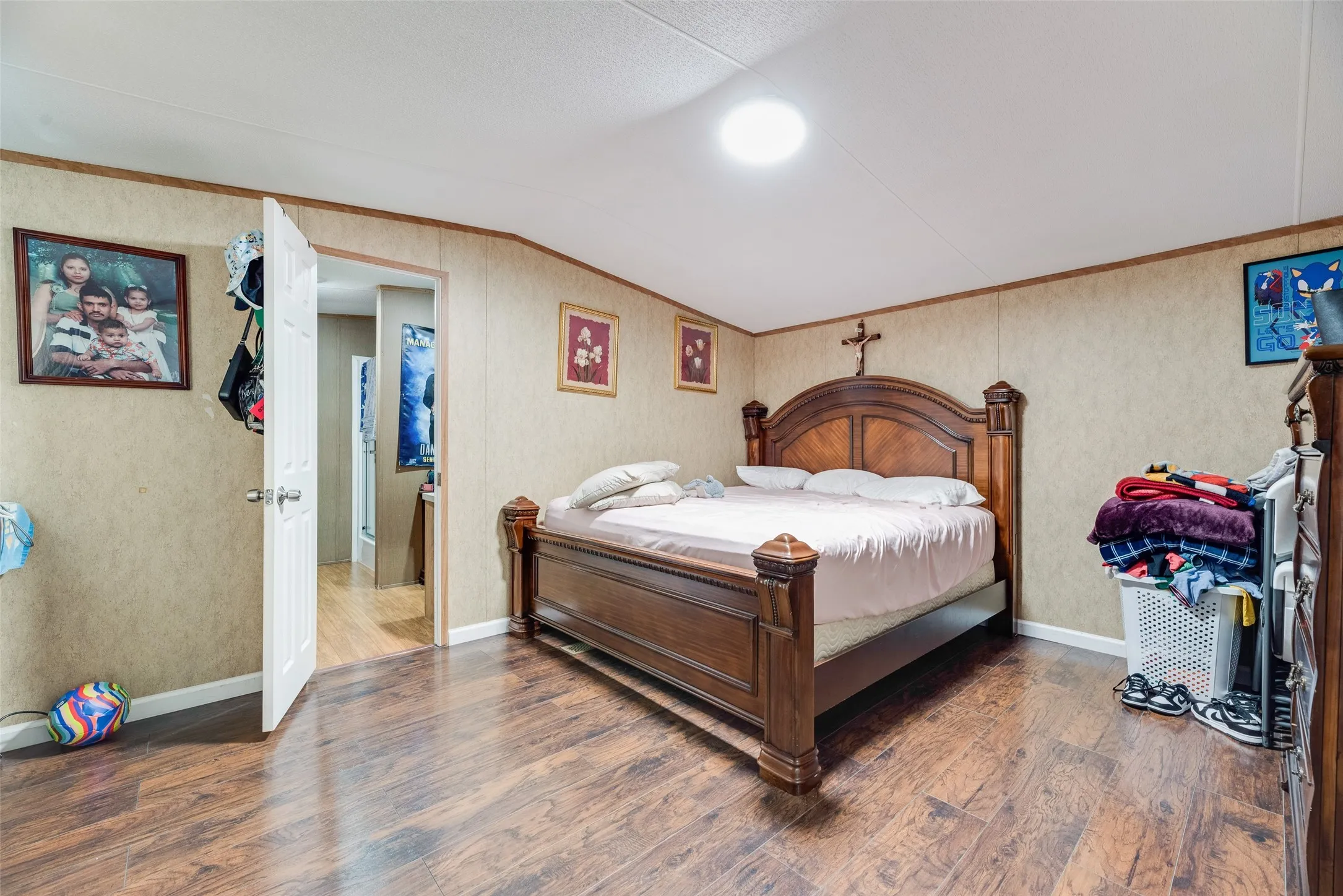 Wood-finish flooring with light-colored walls and a white ceiling