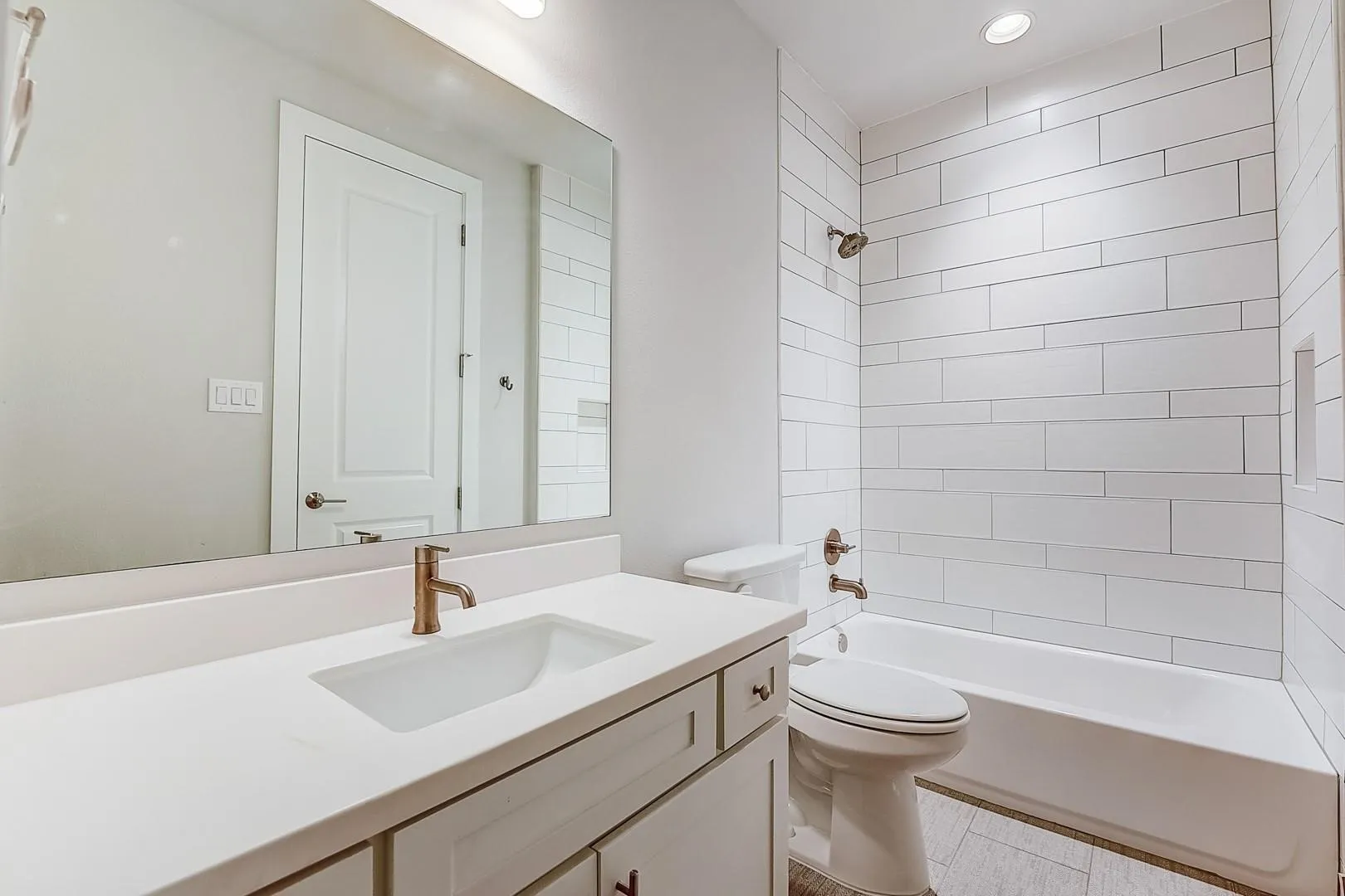 Single vanity with integrated sink and bronze-finish faucet