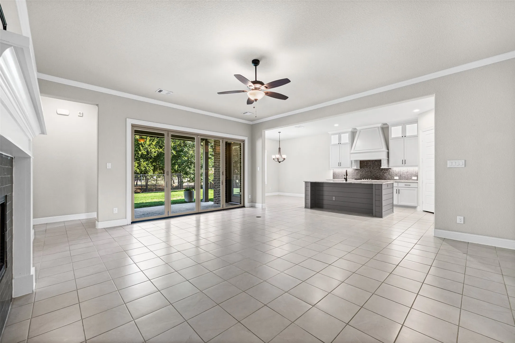 Large living room with fireplace and sliding glass doors to the covered patio.  Open to the kitchen
