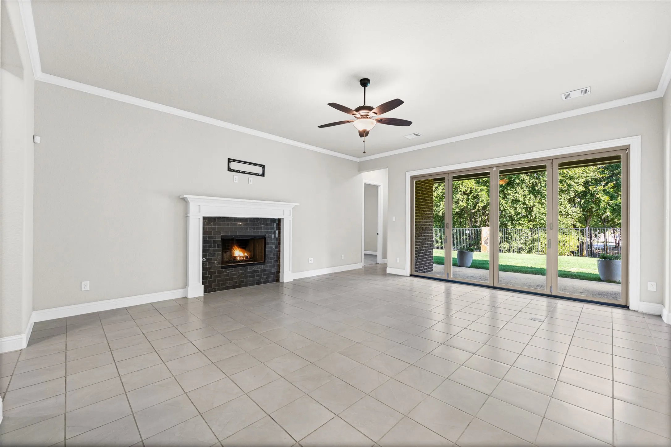 Large living room with fireplace and sliding glass doors to the covered patio