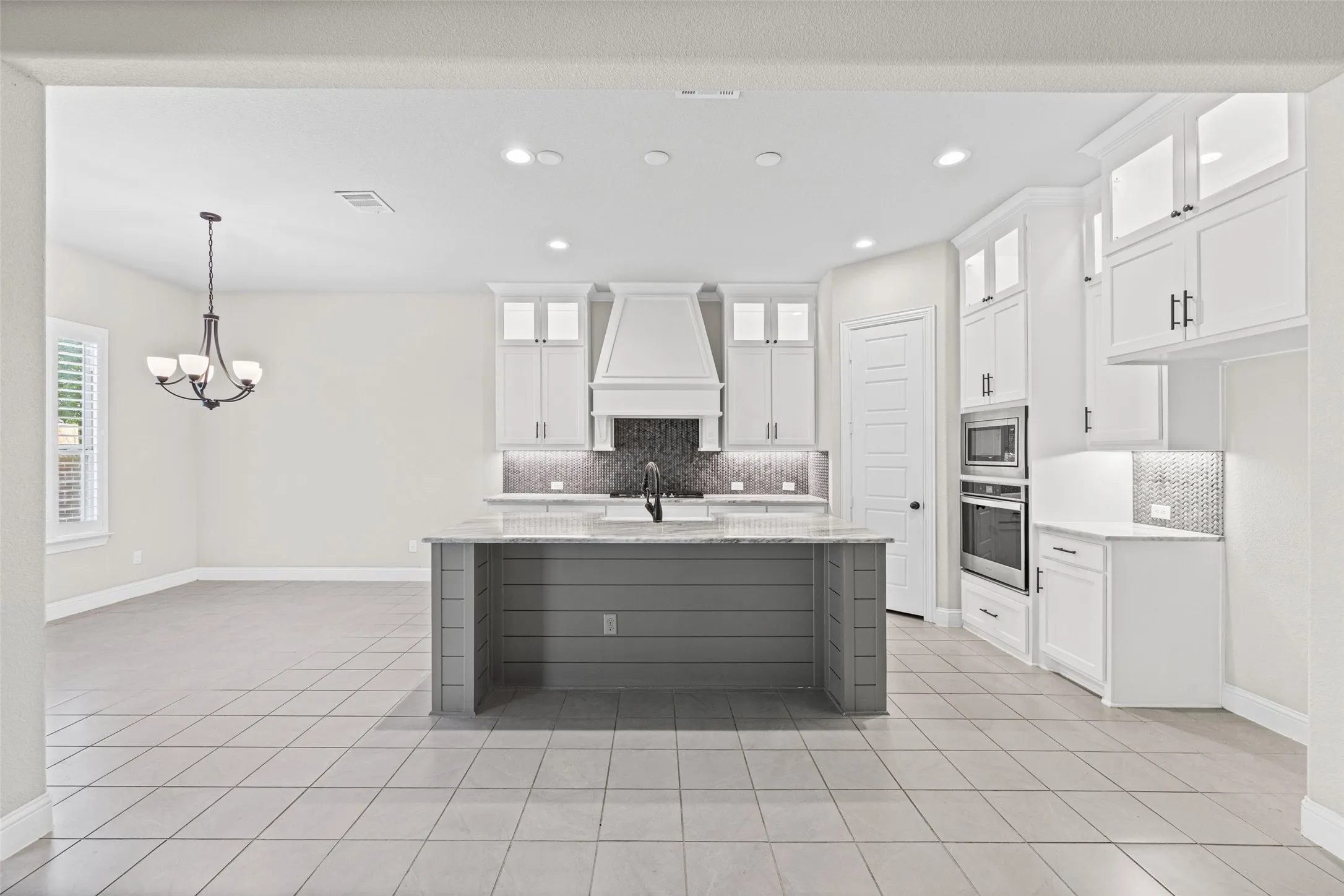 Gorgeous kitchen with stainless appliances, beautiful counters, center island and gas cooktop
