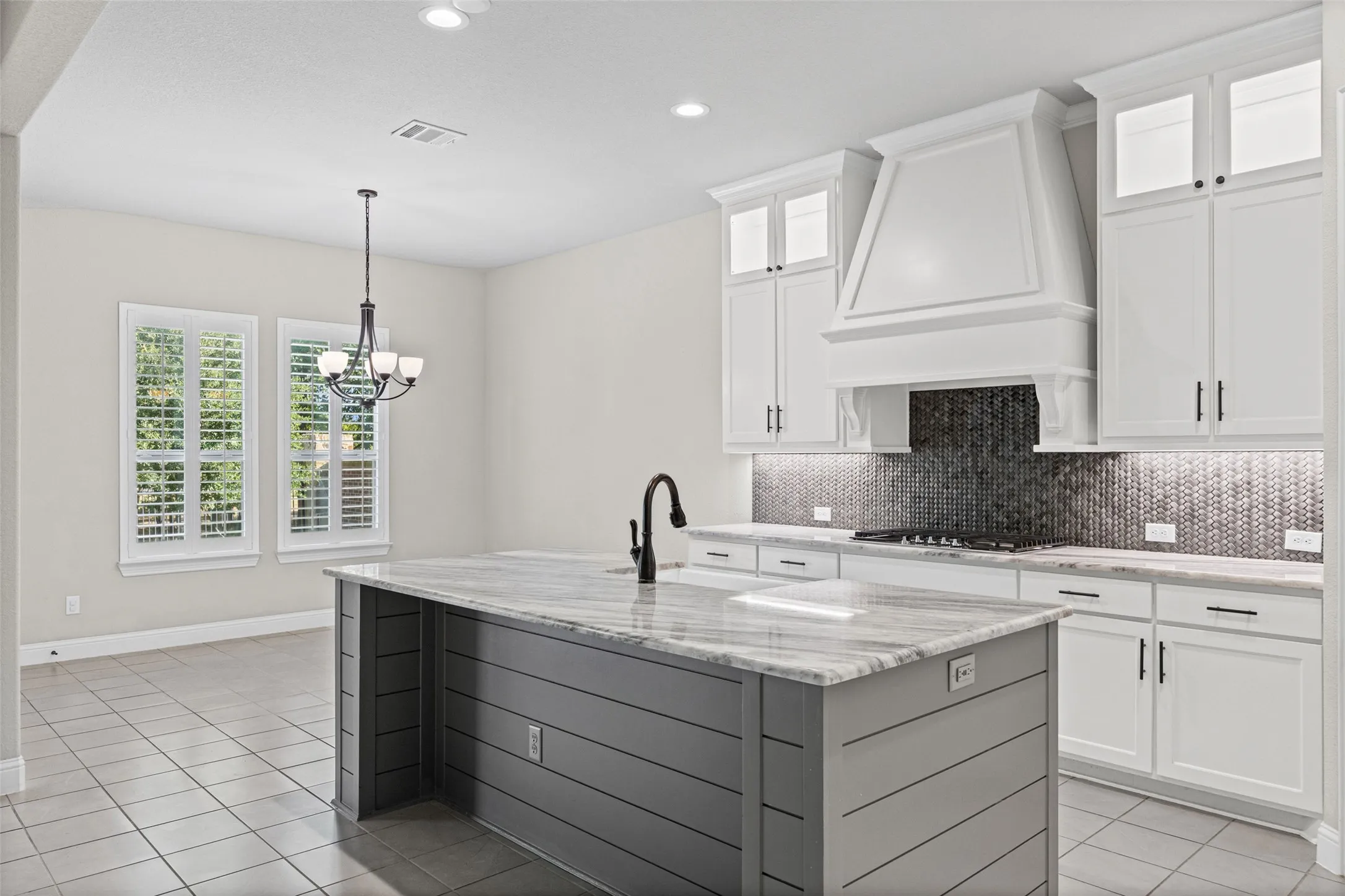 Gorgeous kitchen with stainless appliances, beautiful counters, center island and gas cooktop