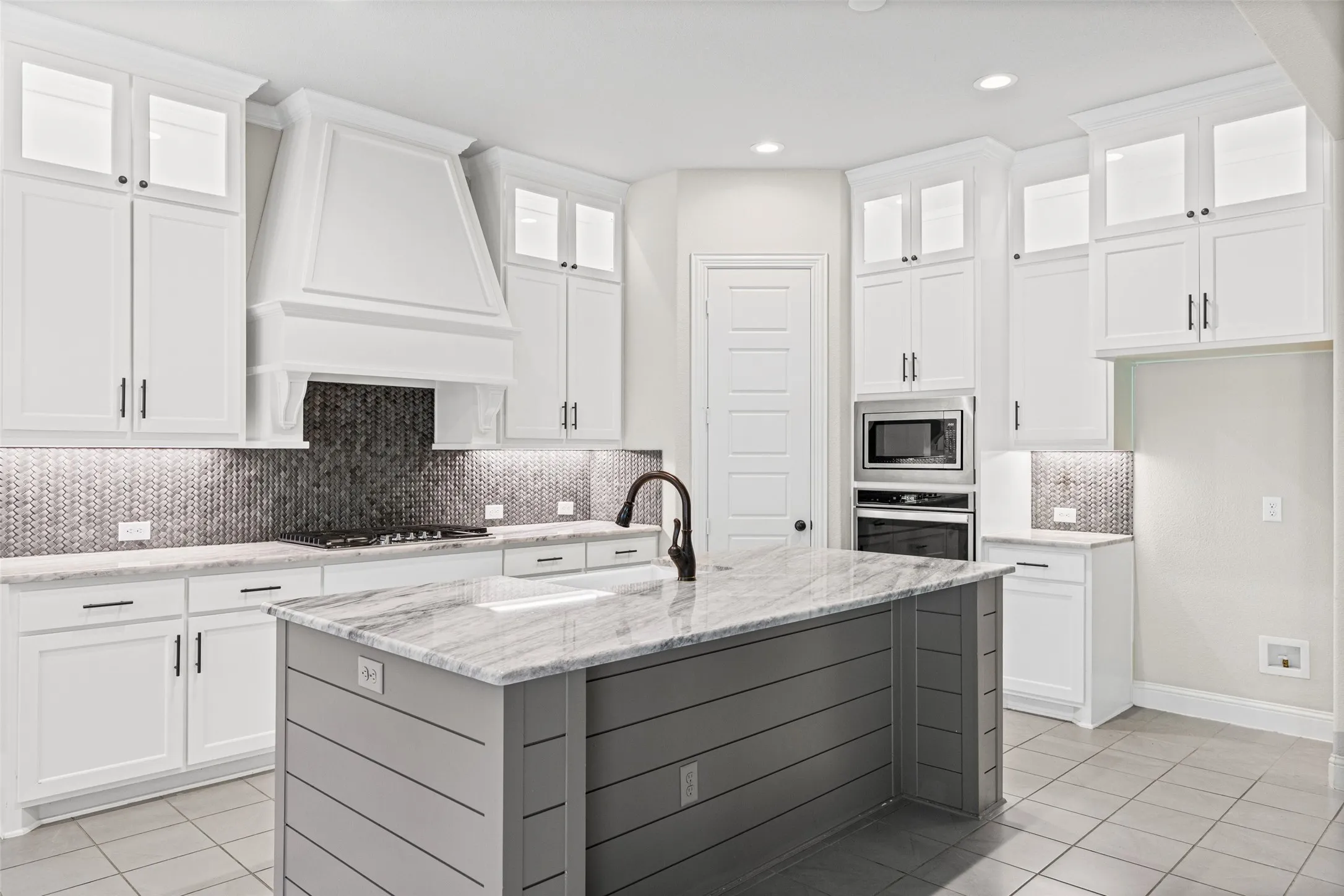 Gorgeous kitchen with stainless appliances, beautiful counters, center island and gas cooktop