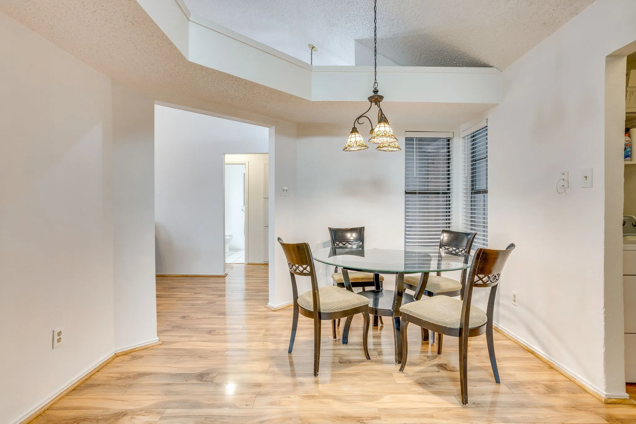 Vaulted ceiling, wood-finish flooring, and built-in shelving