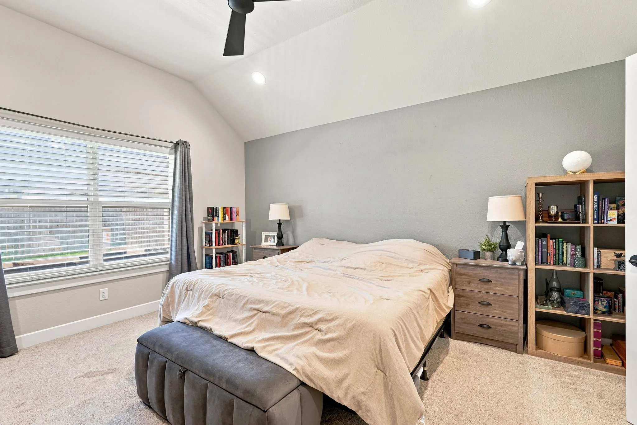 Vaulted ceiling with a ceiling fan, recessed lighting, large window with blinds, and carpeted flooring
