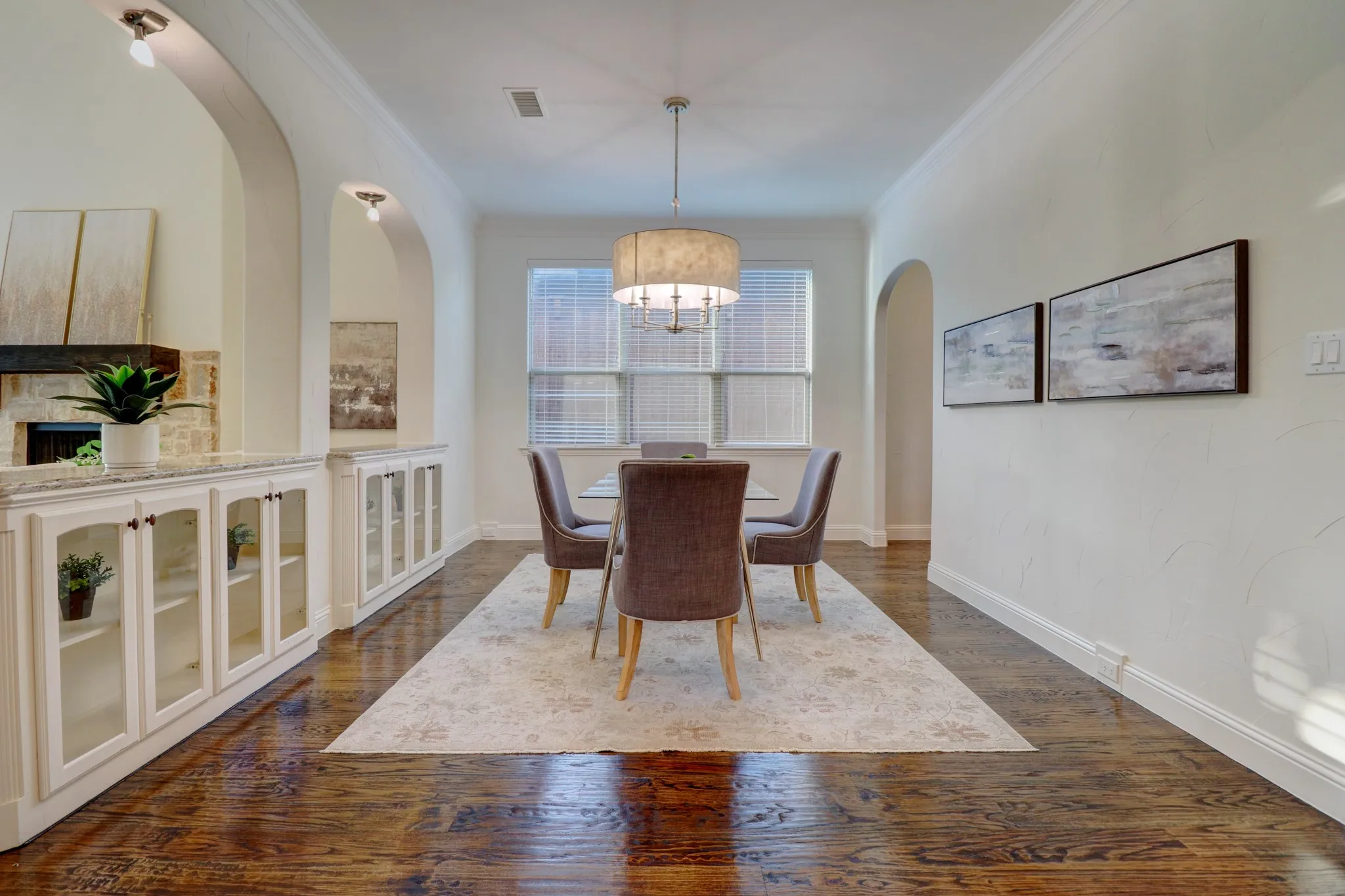 Rich wood-finish flooring complements archway openings