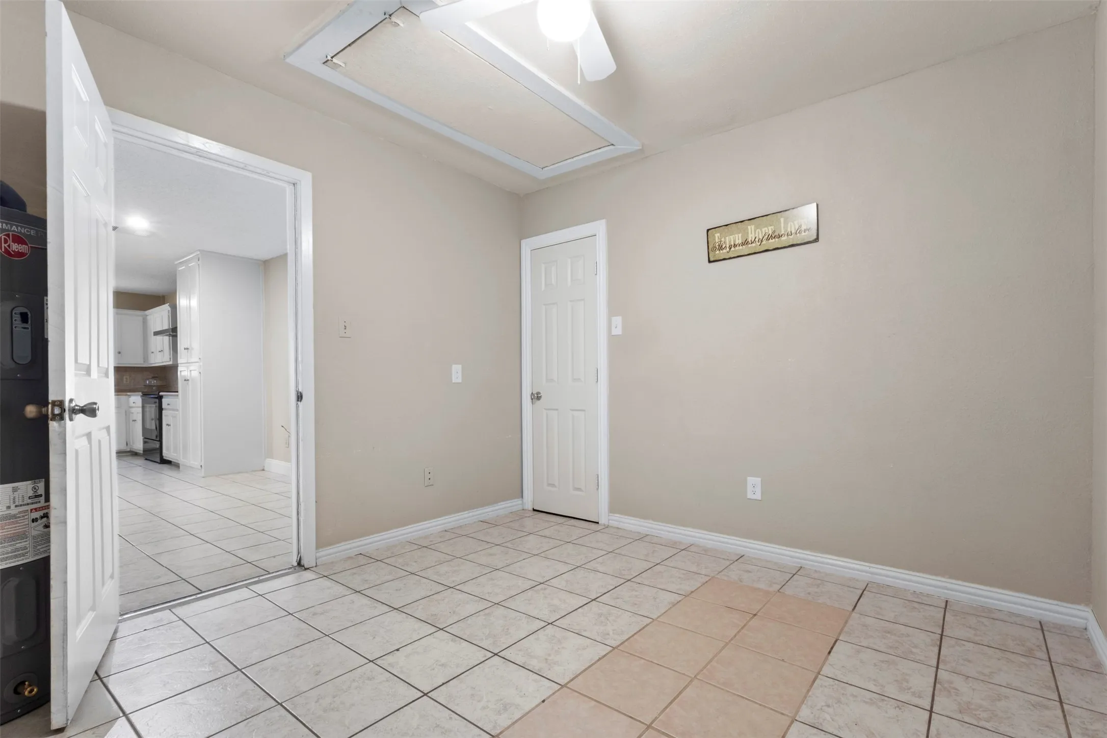 Neutral-toned walls complement the square tile flooring