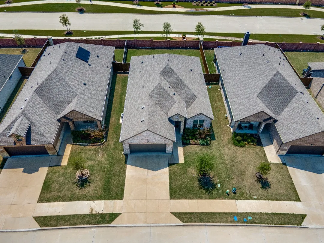 Brick exterior, attached garage, gabled roofline, concrete driveway, and front yard landscaping