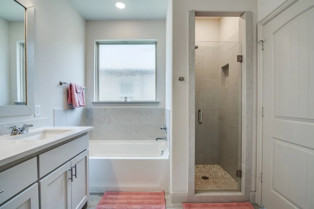 White vanity with integrated sink, polished chrome faucet, and shaker-style cabinetry