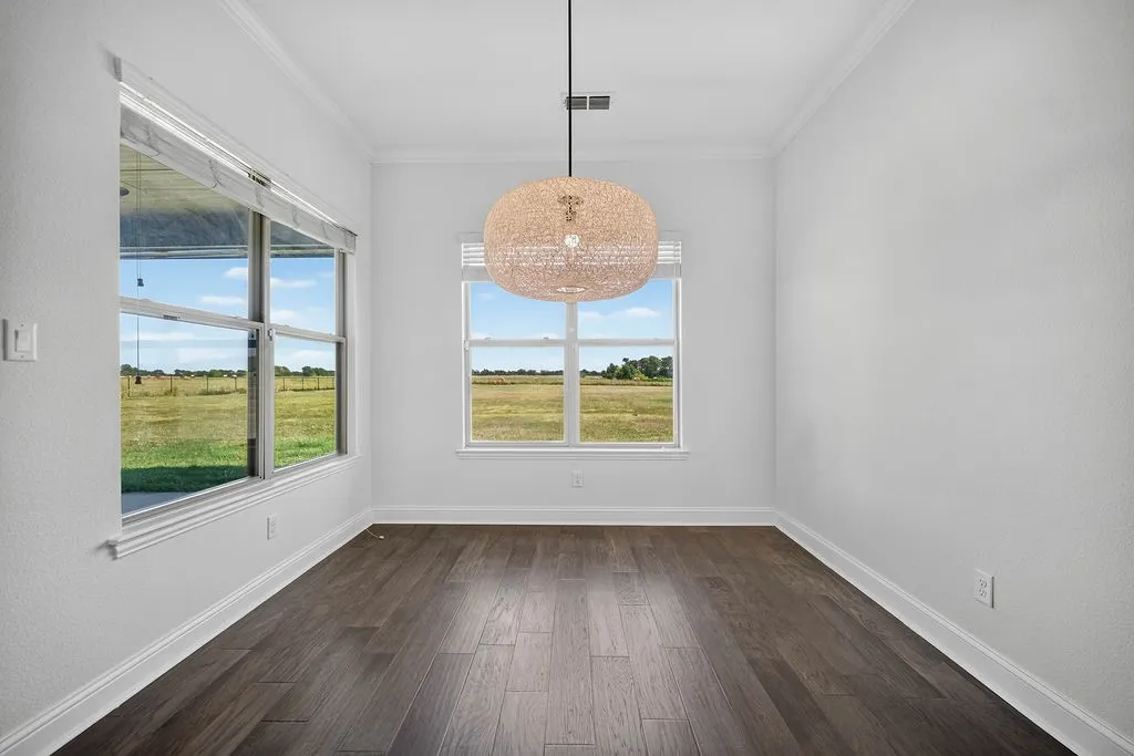 Dark wood-finish flooring with white baseboards