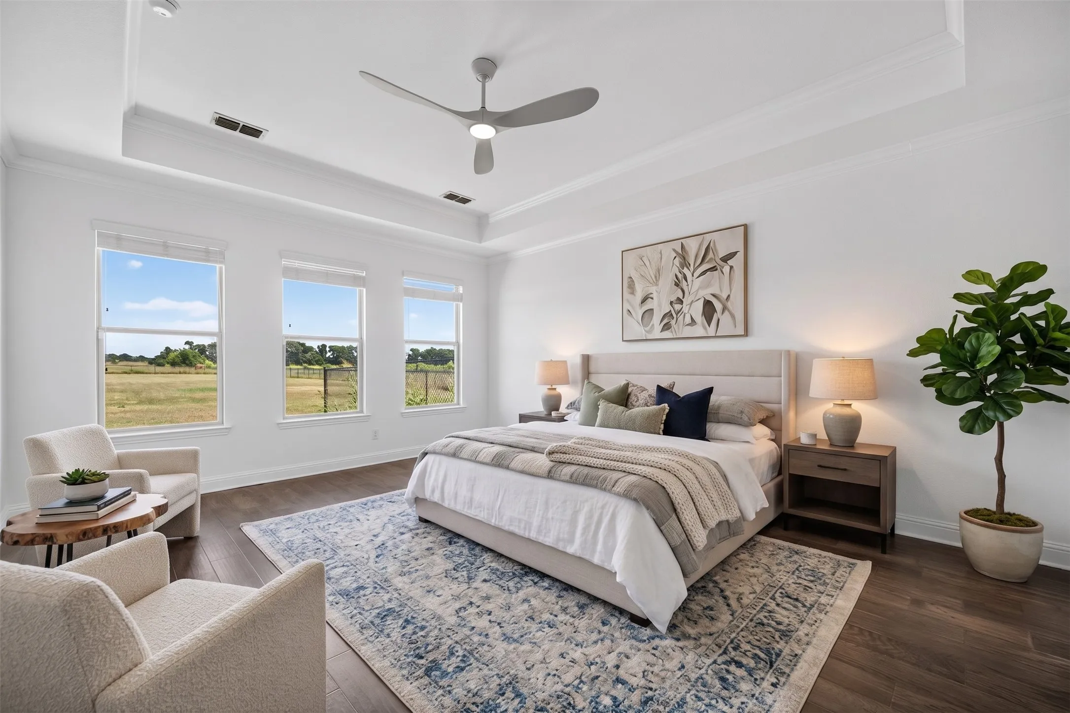 Tray ceiling with crown molding, wood-finish flooring, three large windows, modern ceiling fan, and recessed lighting