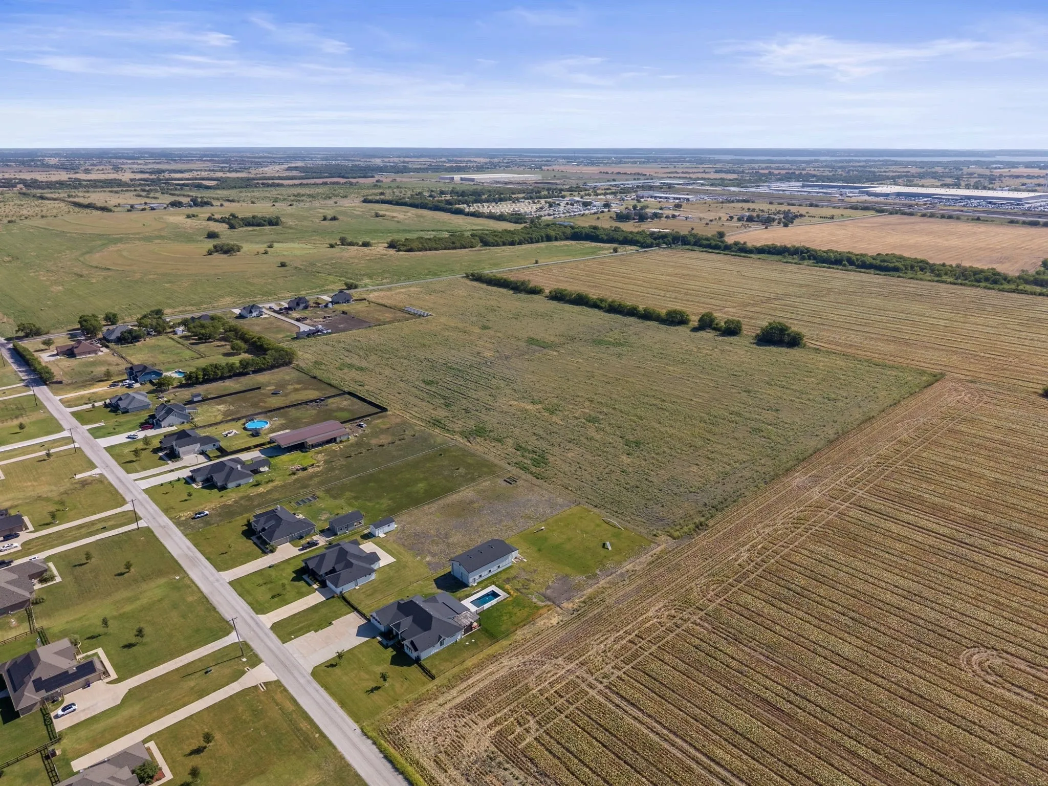 Expansive agricultural land surrounding a developed residential area