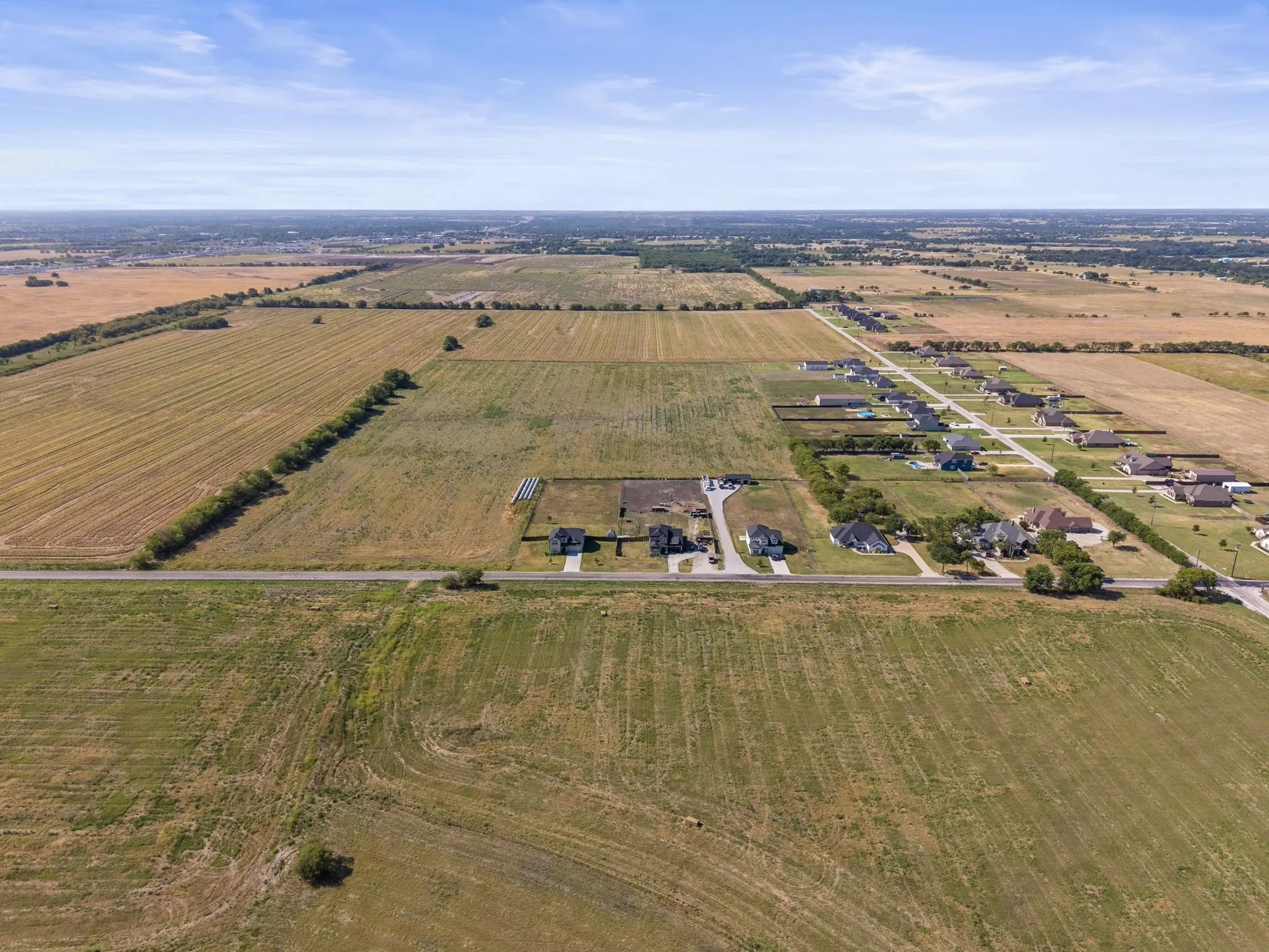 Expansive rural landscape with residential properties and undeveloped land