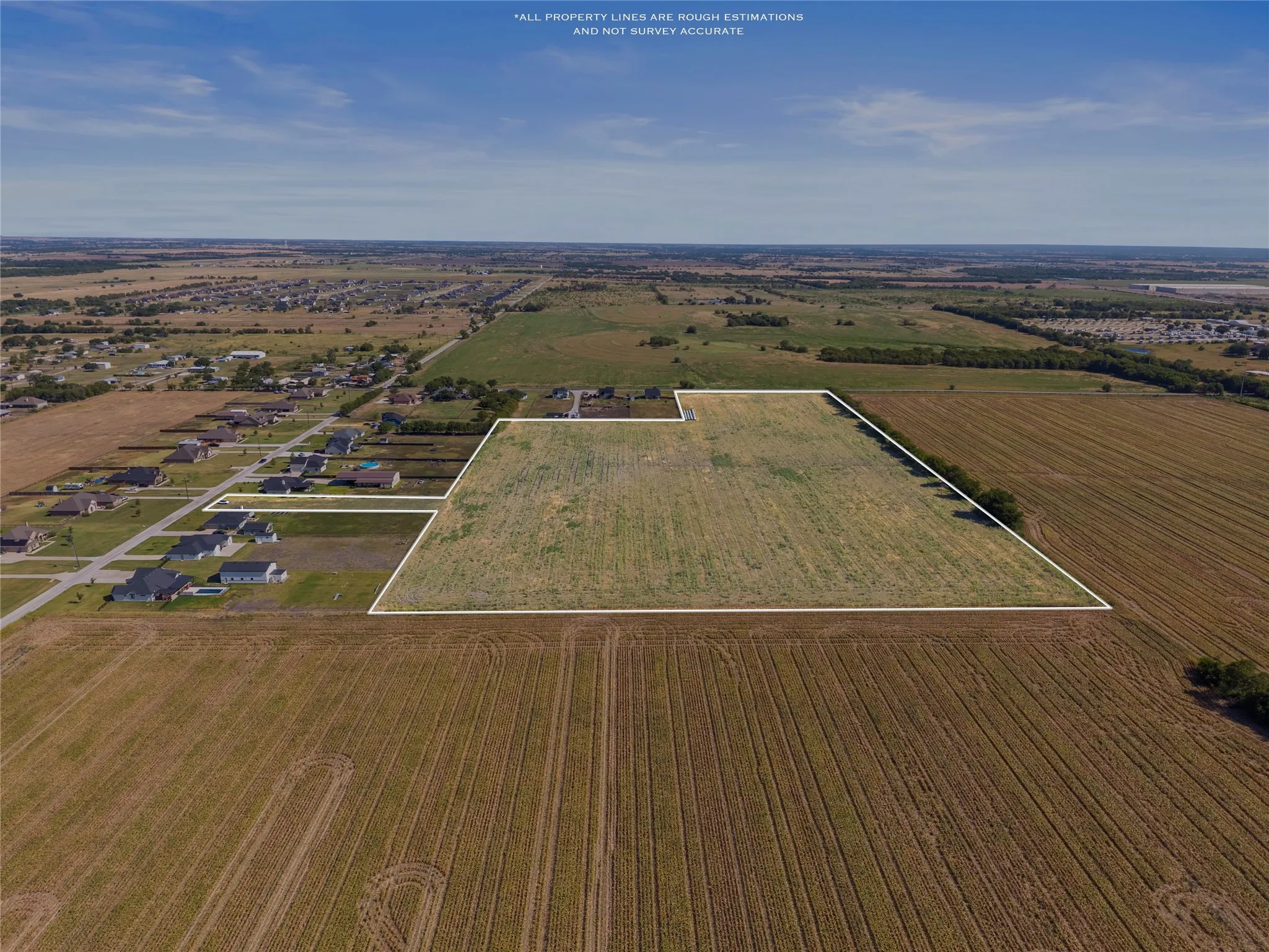 Expansive land parcel with surrounding agricultural fields