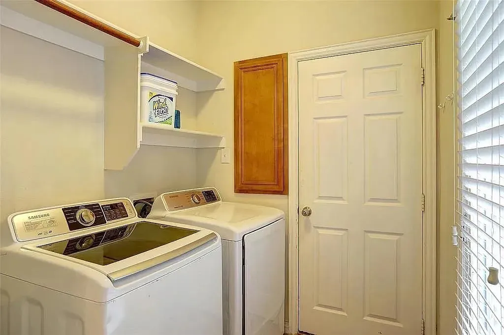 Clothes washing area with cabinet space and washer and dryer