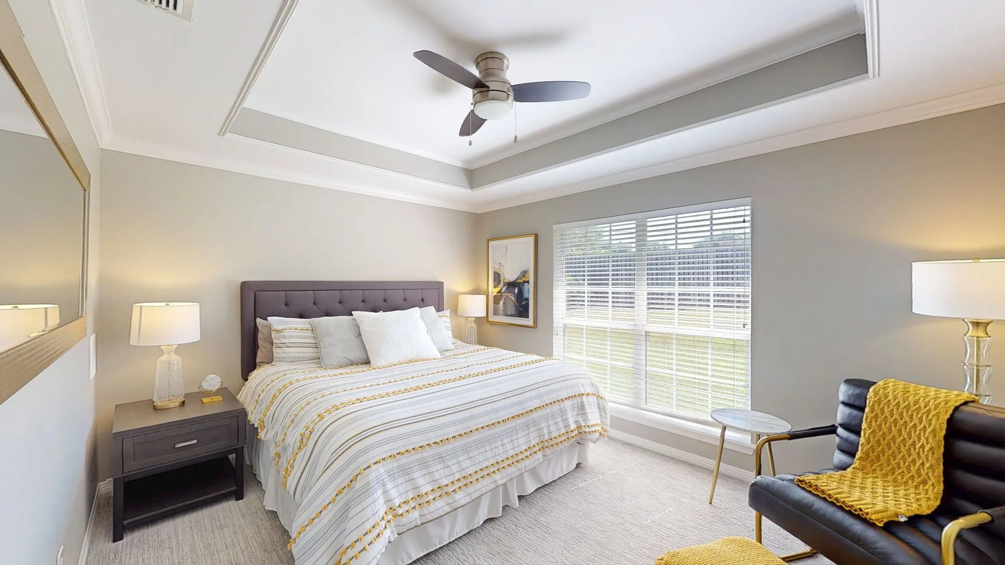 Including a tray ceiling, large window, measures 11'x14'.