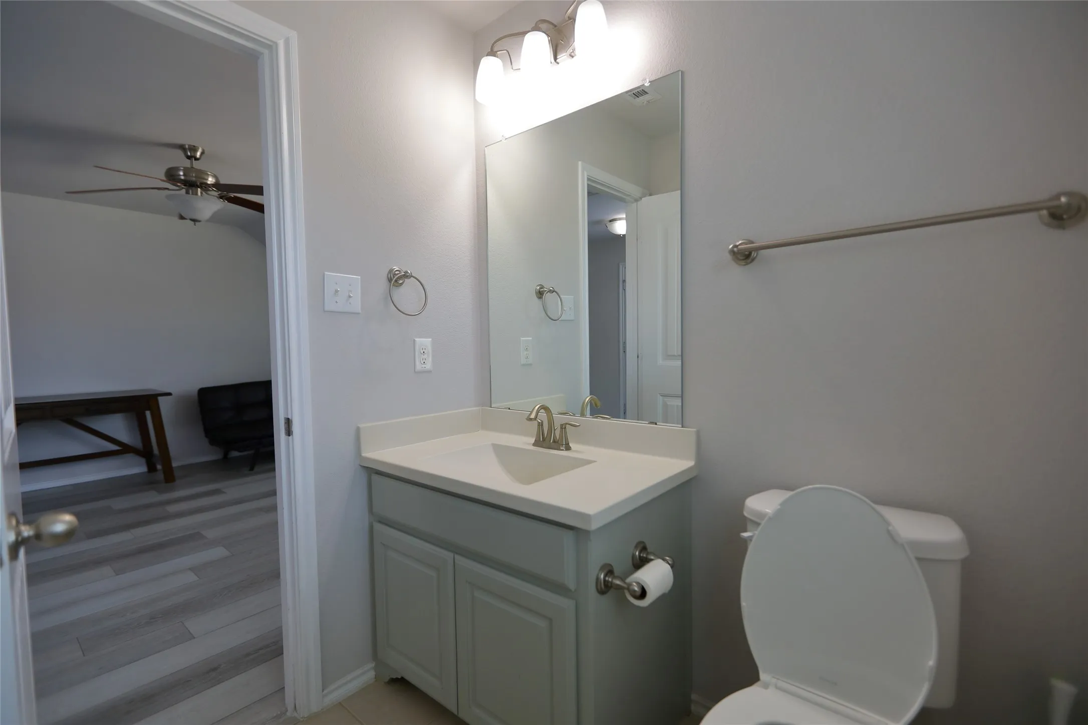 Bathroom featuring a vanity with a light-colored countertop, an undermount sink, and brushed nickel fixtures