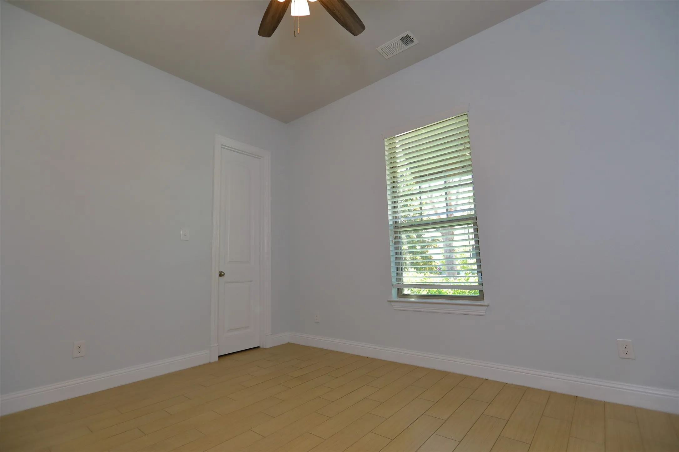 Wood-finish flooring paired with light gray walls