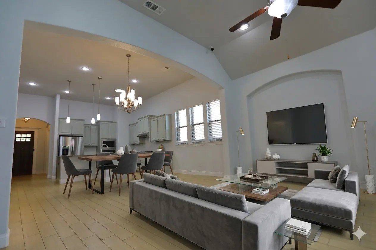 Open-concept living space featuring vaulted ceilings and light wood-finish flooring