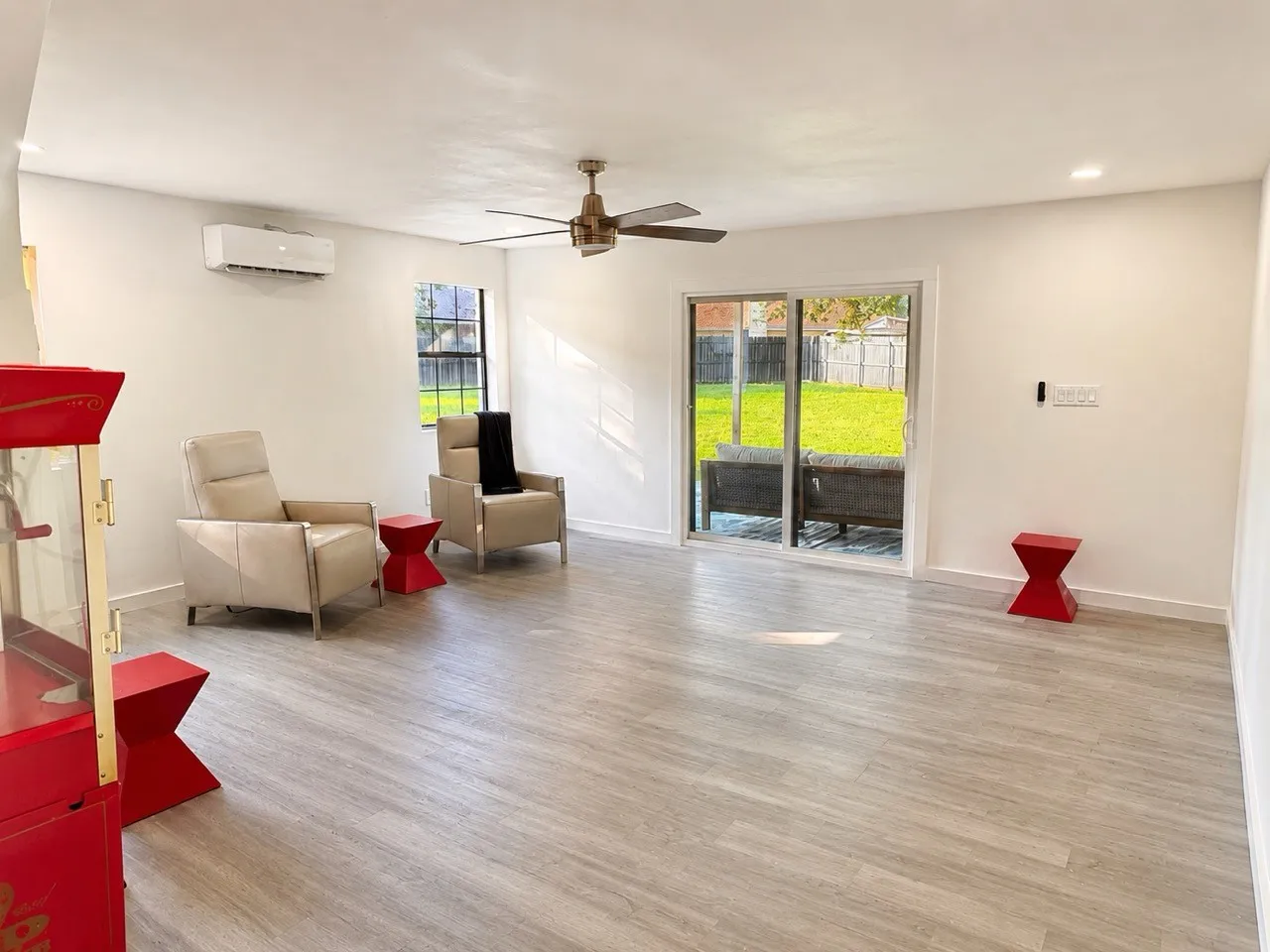 Spacious interior featuring wood-finish flooring, a ceiling fan, recessed lighting, and a sliding glass door