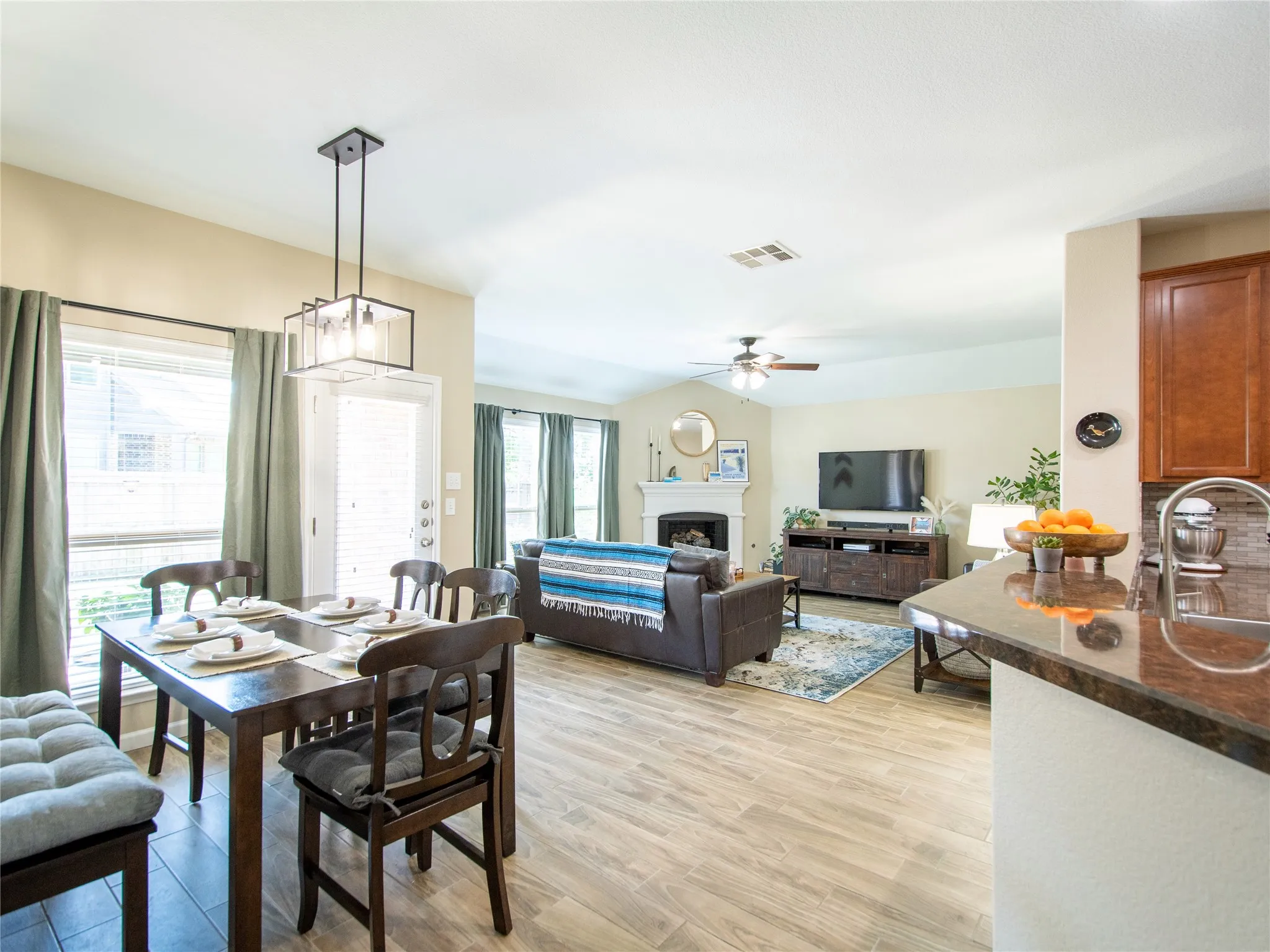 Open-concept living space with wood-finish flooring
