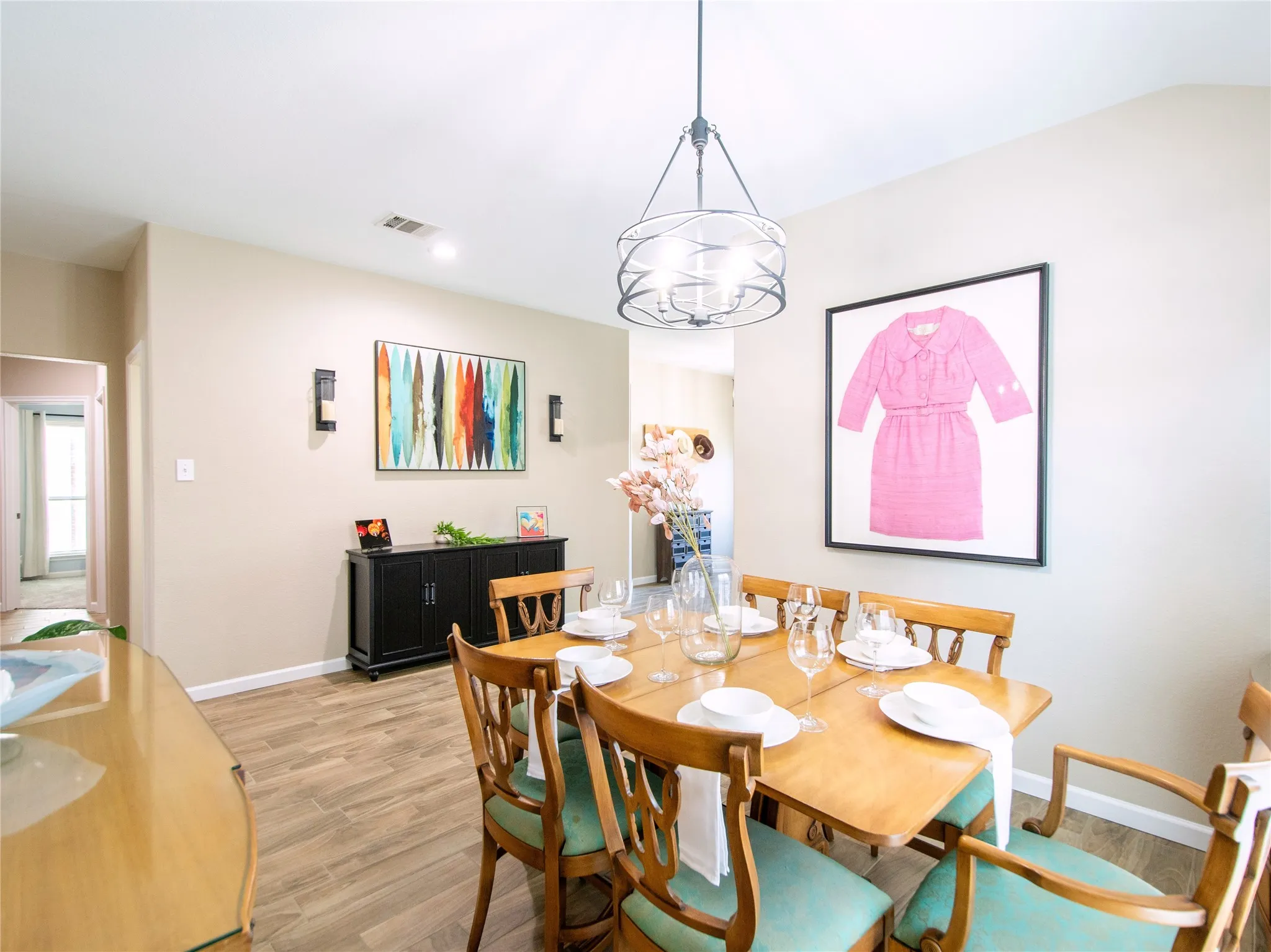 Recessed lighting, wood-finish flooring, and a modern chandelier