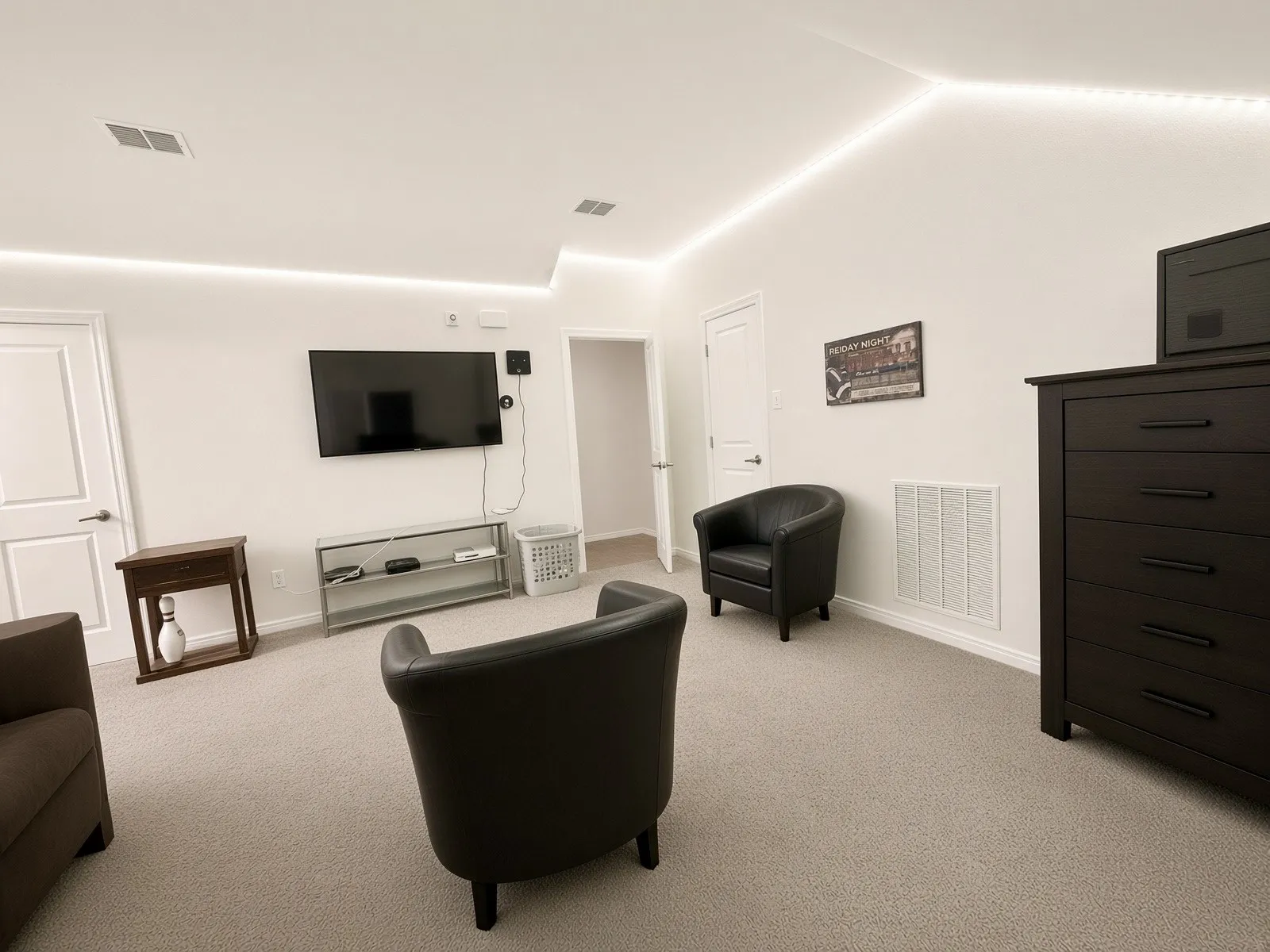 Recessed ceiling lighting, sloped ceiling, white interior doors, and light-colored carpeting