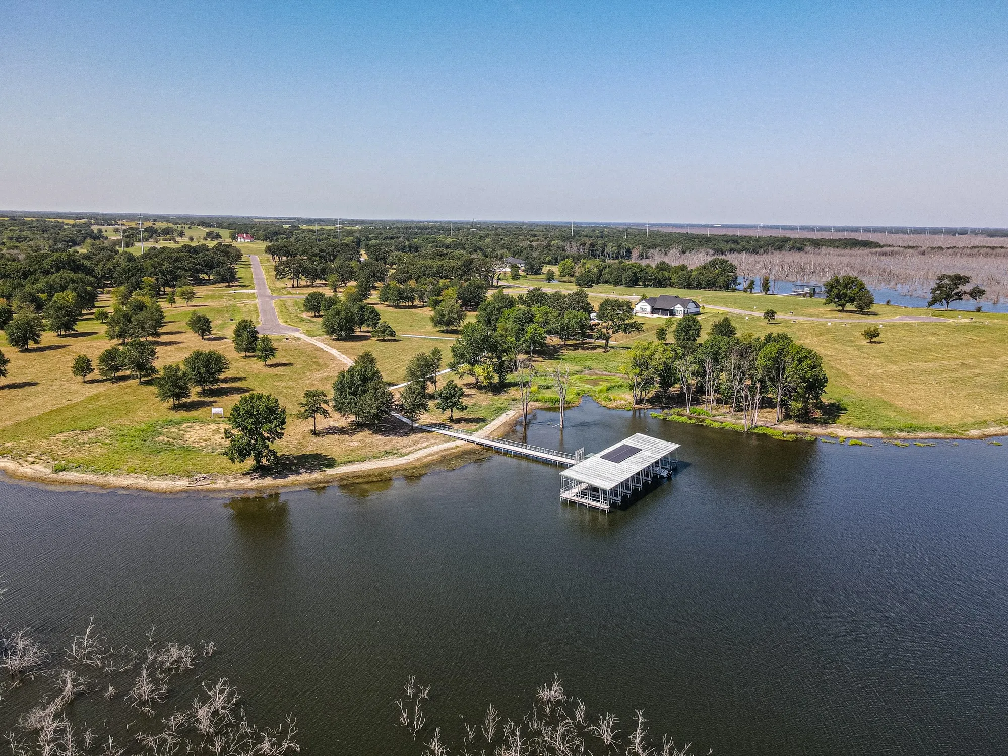 Waterfront property with private dock featuring a boat slip and covered seating area