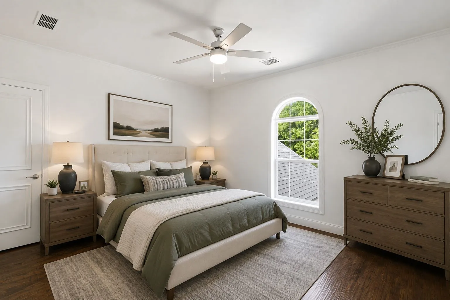 Hardwood flooring, arched window, ceiling fan, paneled door, and recessed lighting
