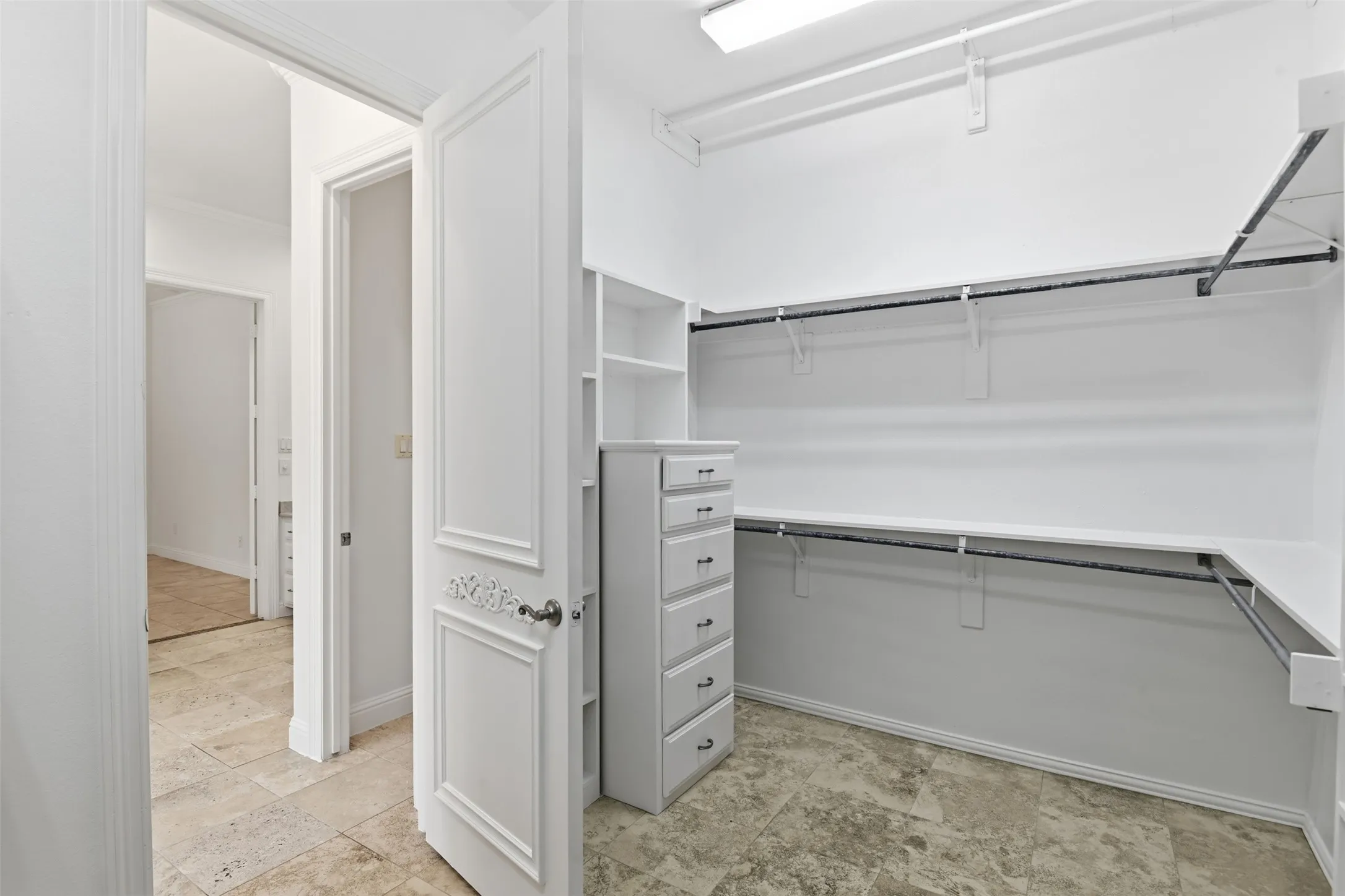 Custom built-in closet system featuring multiple shelves and hanging rods