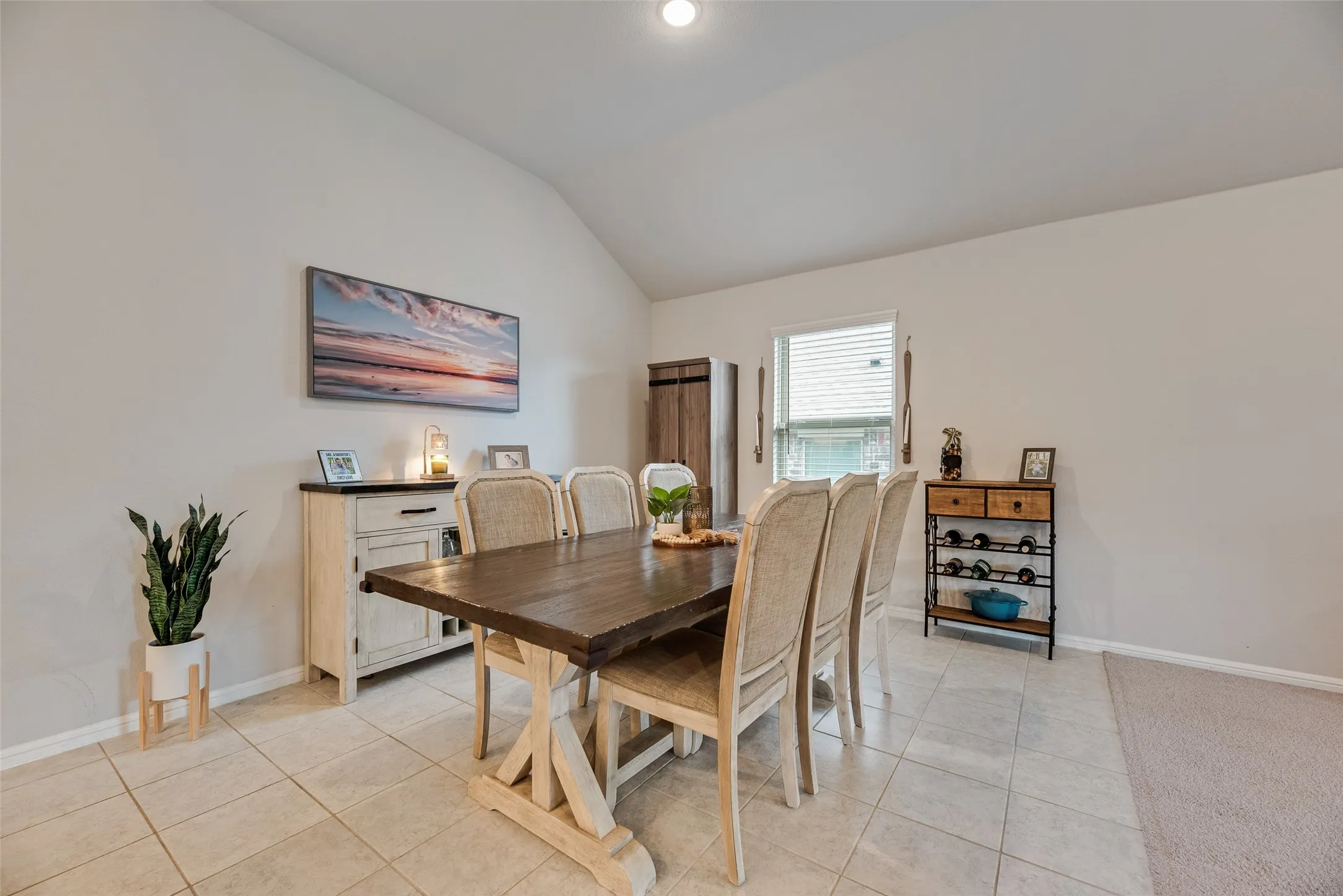 Vaulted ceiling, recessed lighting, tile flooring, window with blinds
