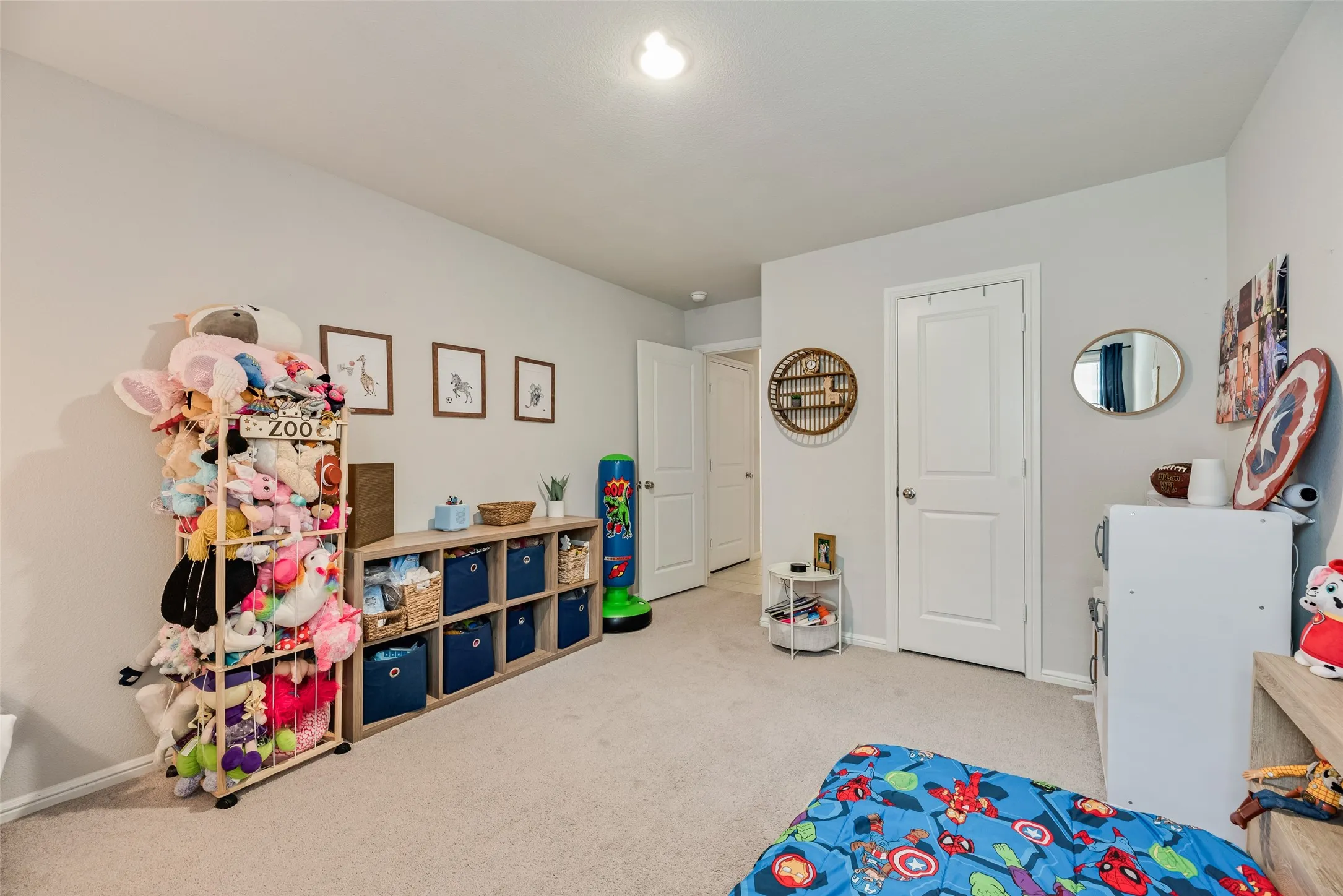 Carpeted flooring, light neutral wall paint, and overhead lighting