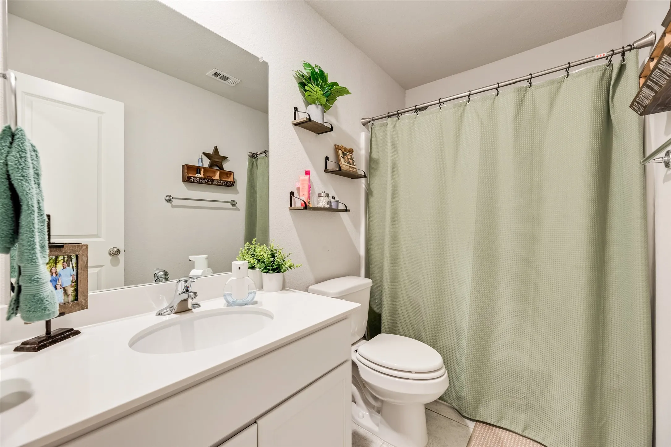 Vanity with a single basin, chrome faucet, and white countertop