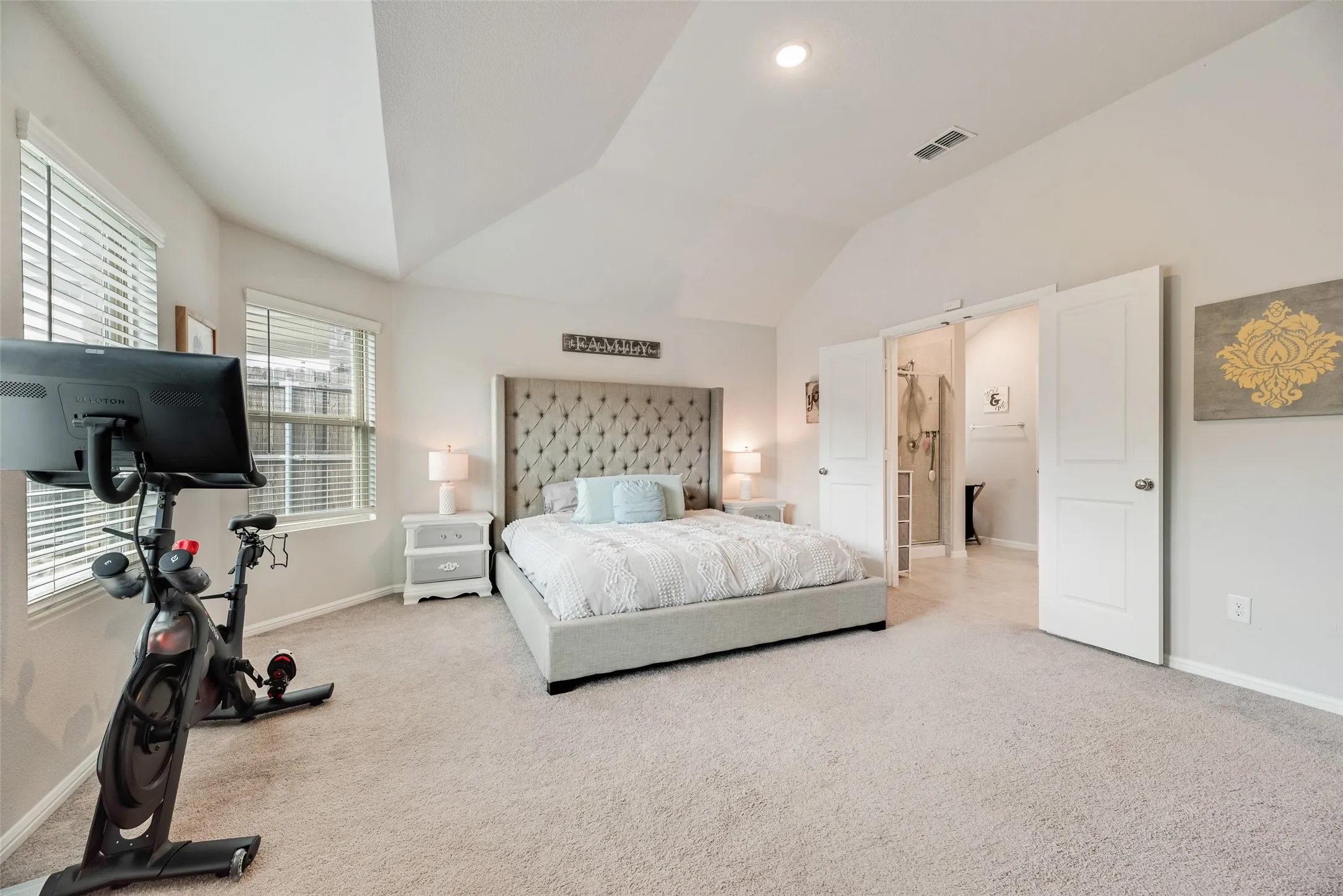 Light-colored carpeted flooring, vaulted ceiling, recessed lighting, and white paneled doors