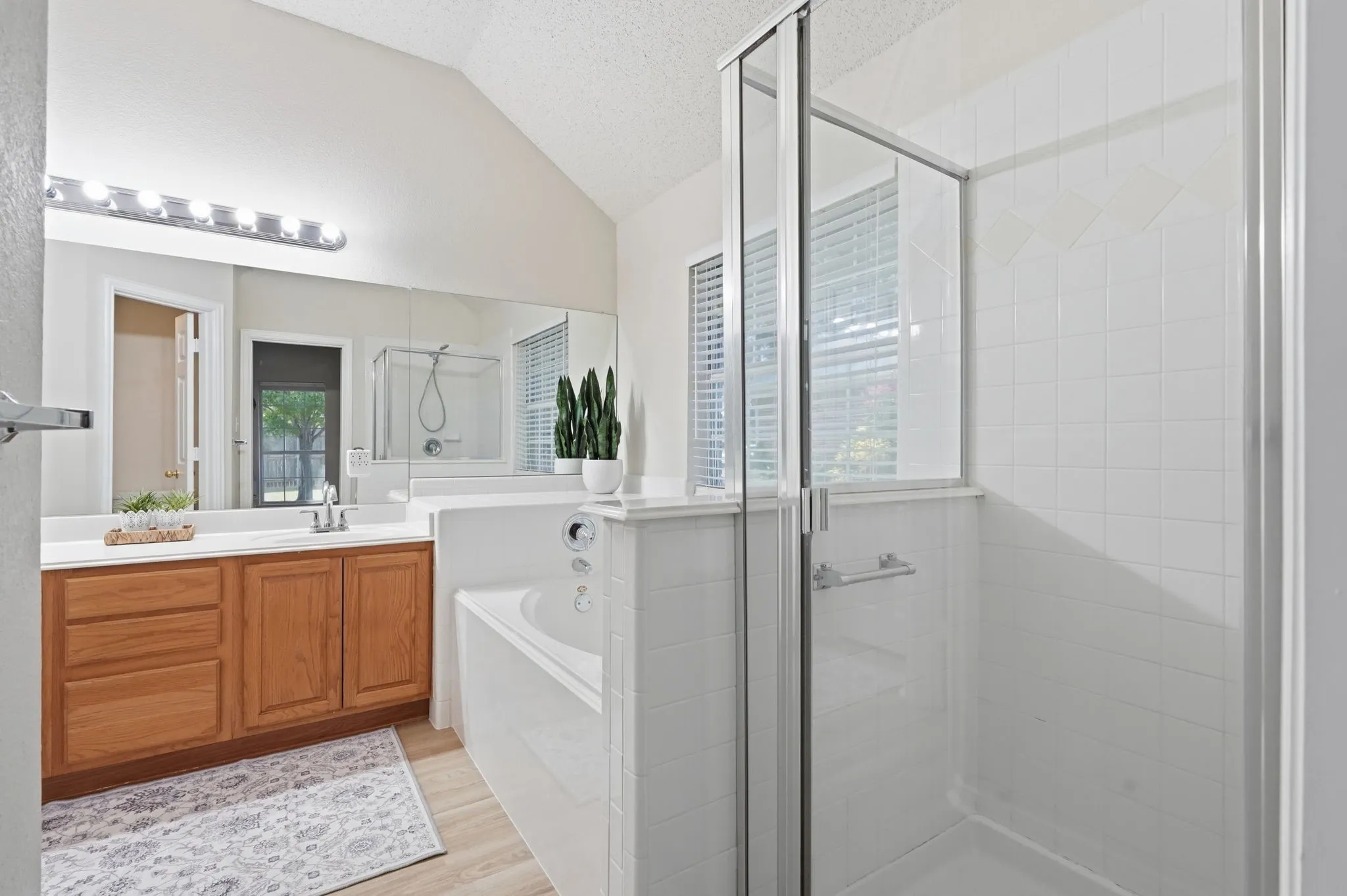 Primary bathroom with dual sinks, separate shower & garden tub