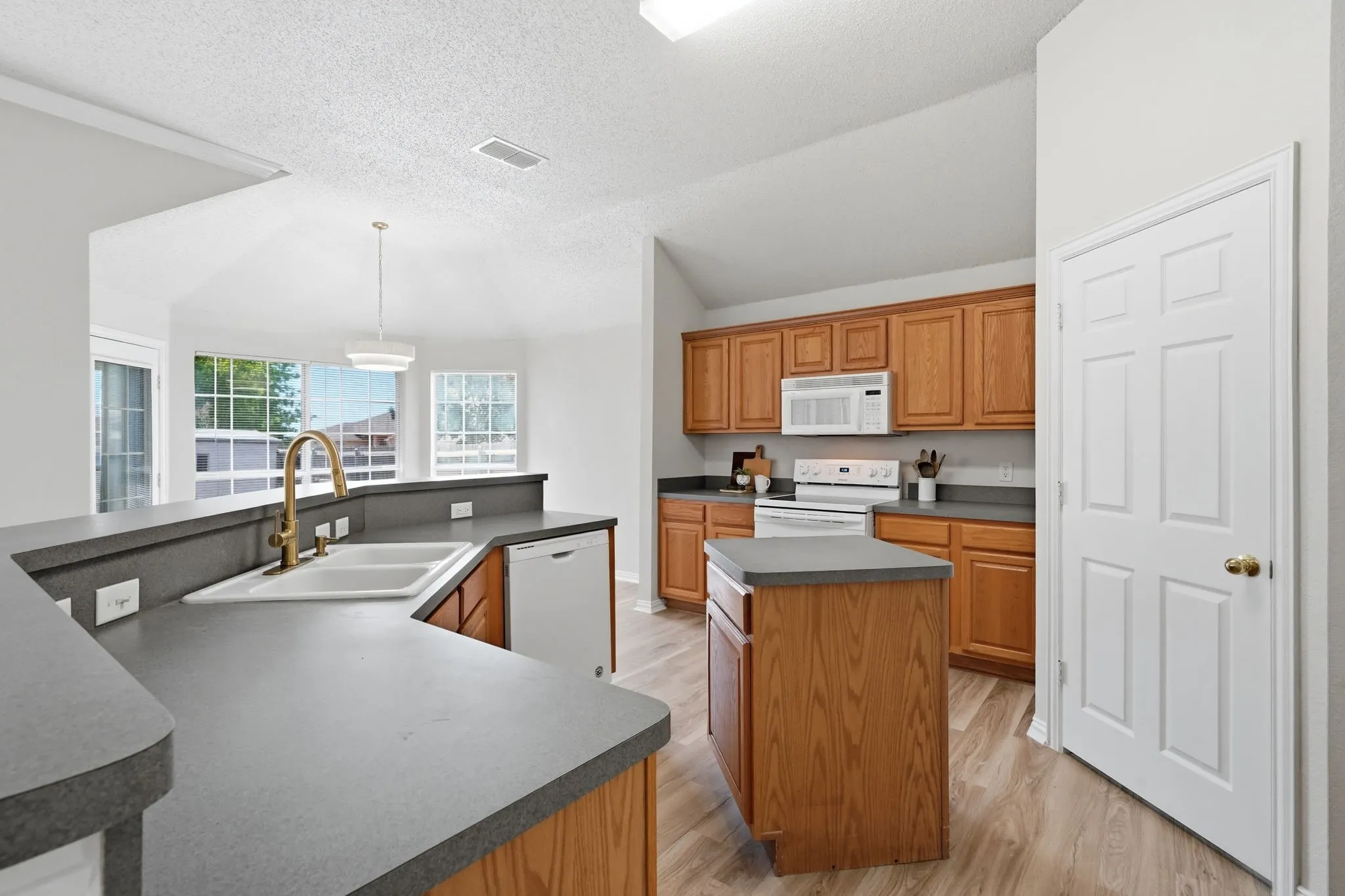Kitchen featuring oversized central island,  double basin sink with  updated faucet & 2nd island for meal prep