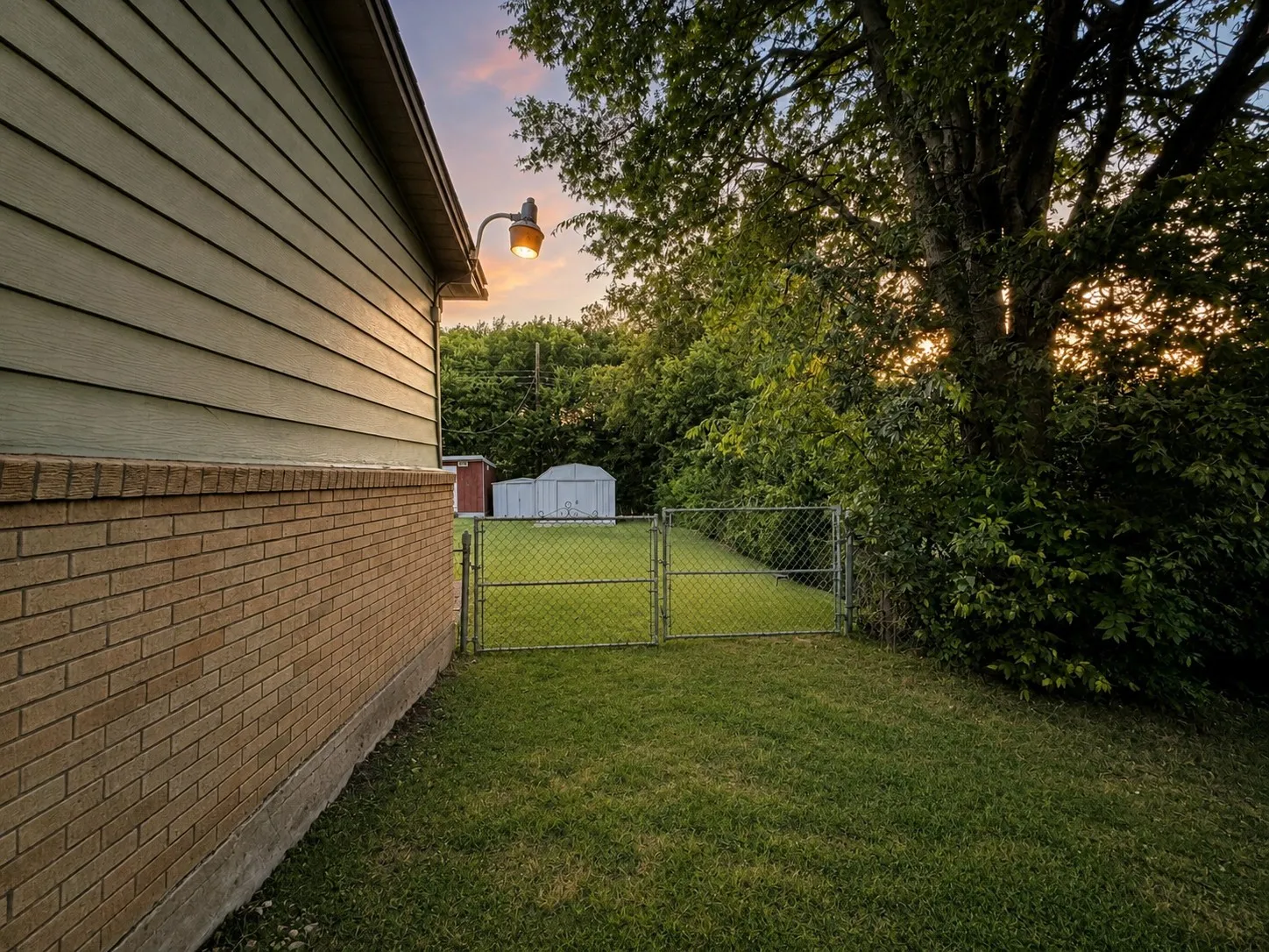 Right side yard with double gate. Portions of this photo have been digitally enhanced.