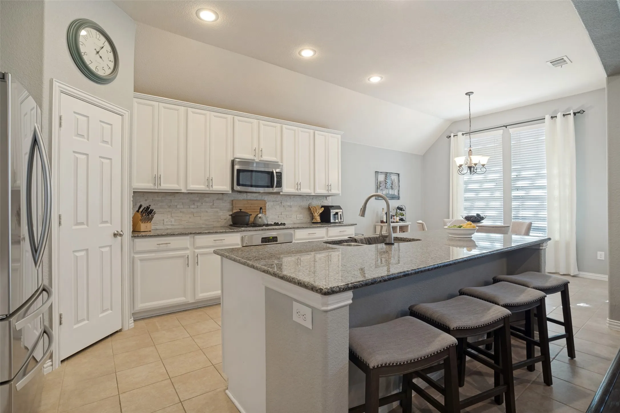 The kitchen offers ample storage and a walk in pantry