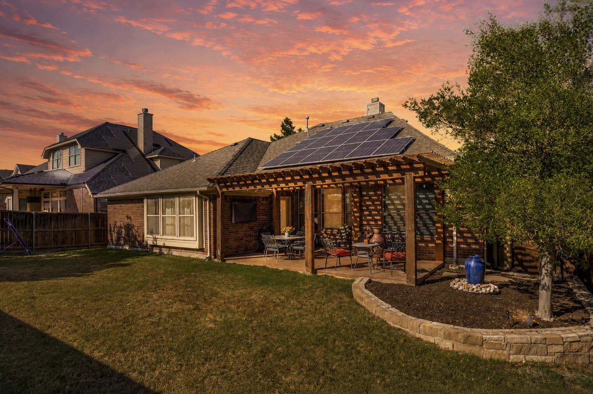 Fabulous Backyard with covered patio. Solar shingles are great for your utility savings.