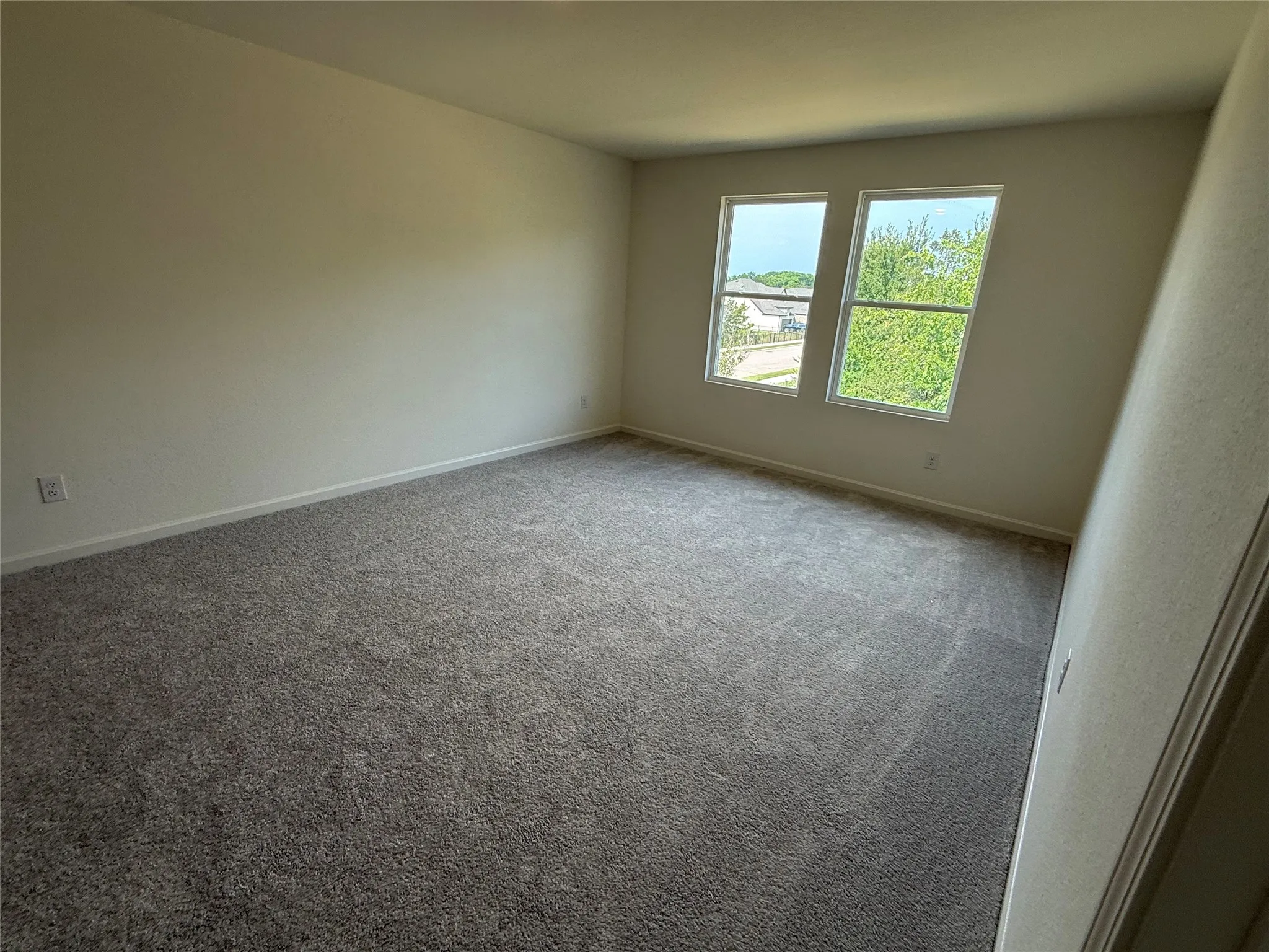 Neutral-toned walls complement the gray carpeting