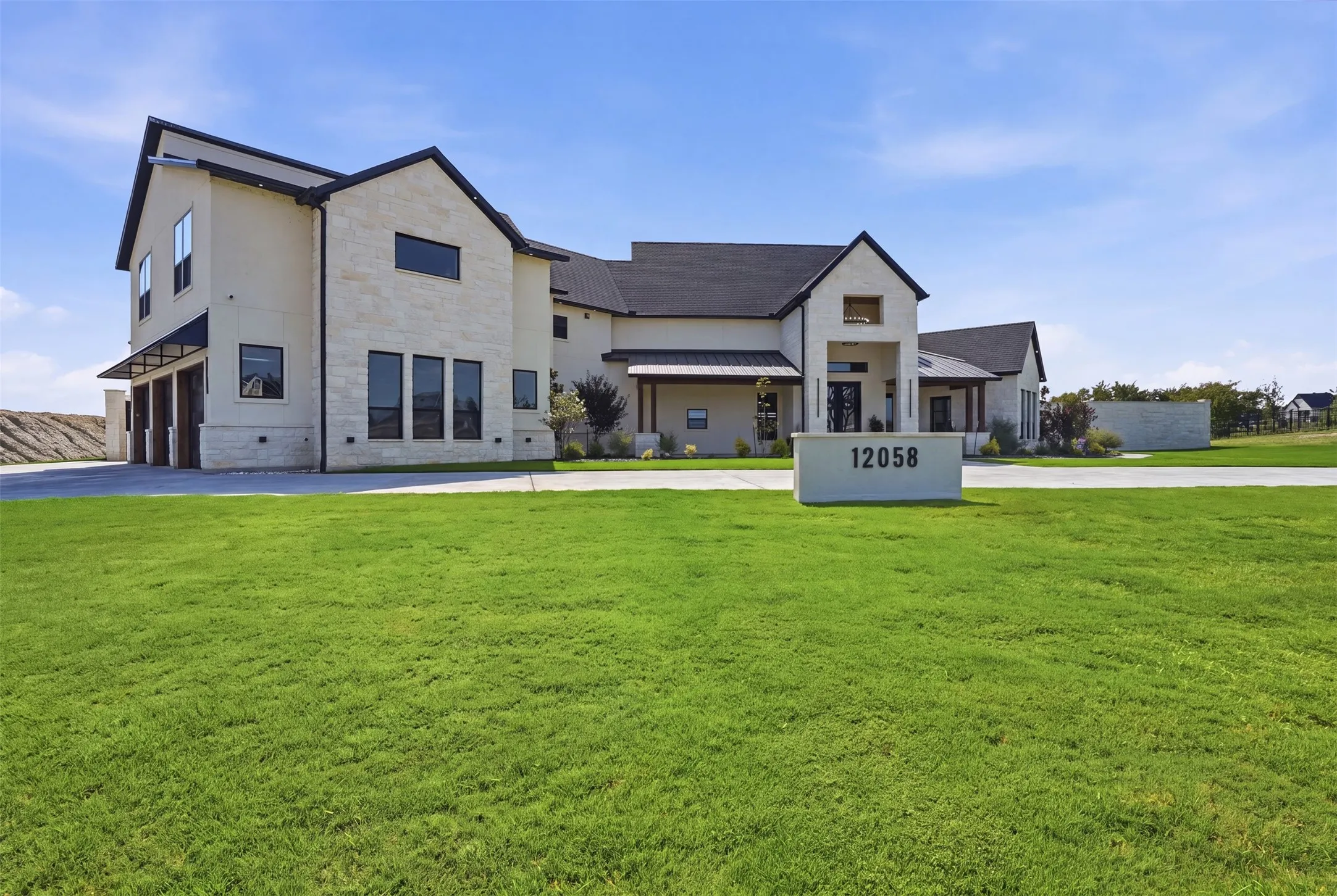 Modern farmhouse residence showcasing a light-finished exterior with multi-gabled rooflines, expansive windows, and clean architectural detailing